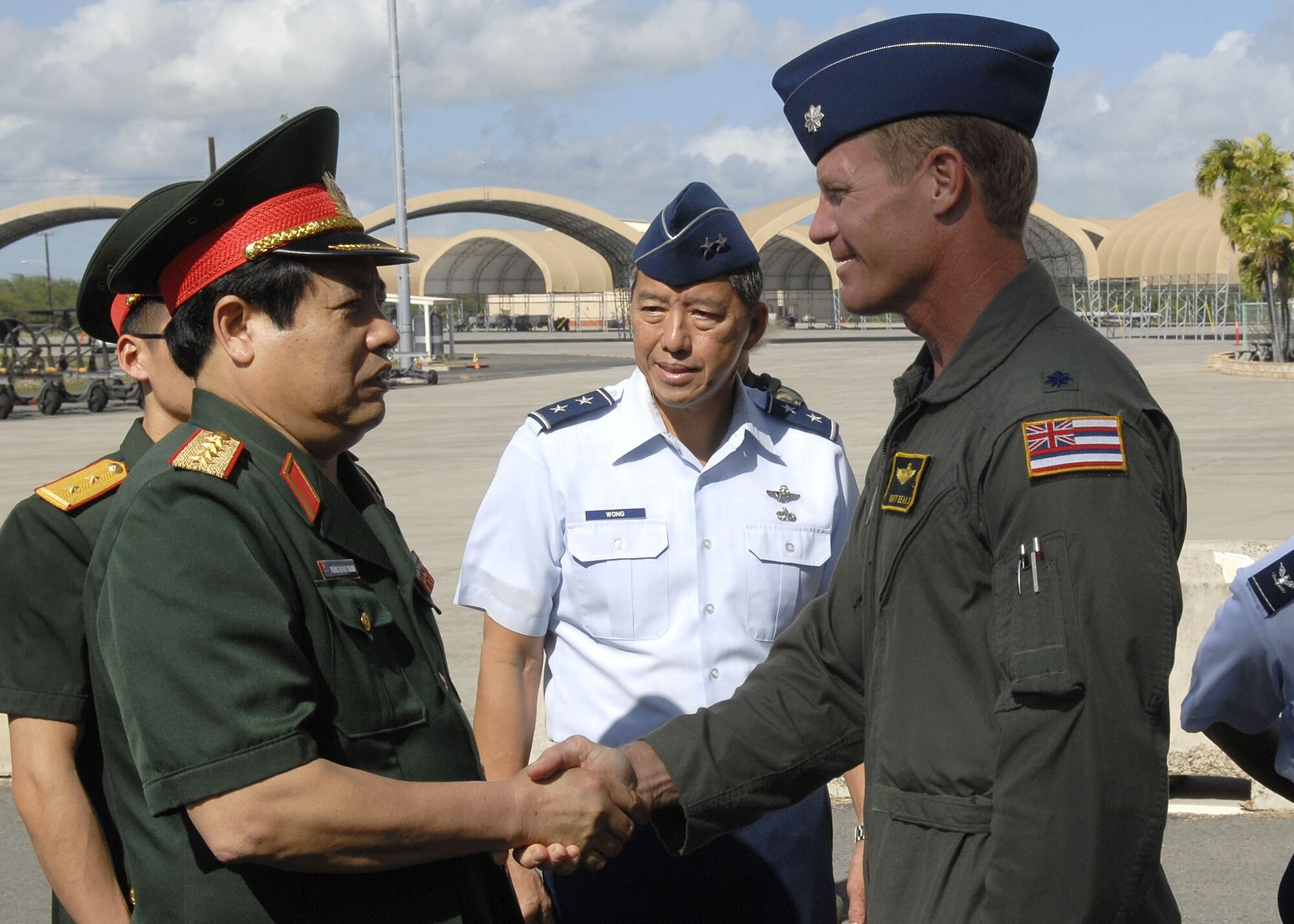 Maj. Gen Darryll Wong, Chief of Staff, Hawaii Air National Guard and commander of the Hawaii Air National Guard, and Lt. Col. Matt Beals , welcome Vietnamese, Minister of Defense, Gen. Phung Quang Thanh and his delegation, while explaining F-15 capabilites, during a tour of Hickam Air Force Base, Hawaii, on Dec. 11. Gen. Phung Quang Thanh was accompanied by a delegation of 13 members, which consisted of both Vietnamese Army and Navy personnel. (U.S. Air Force photo/Tech. Sgt. Jerome S. Tayborn)
