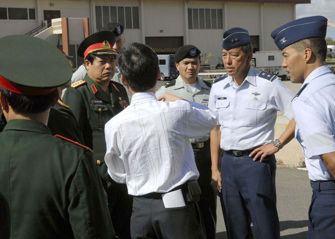 Maj. Gen Darryll Wong, Chief of Staff, Hawaii Air National Guard and commander of the Hawaii Air National Guard, and Brig. Gen. (Select) Kim, welcome Vietnamese, Minister of Defense, Gen. Phung Quang Thanh and his delegation, while explaining F-15 capabilites, during a tour of Hickam Air Force Base, Hawaii, on Dec. 11. Gen. Phung Quang Thanh was accompanied by a delegation of 13 members, which consisted of both Vietnamese Army and Navy personnel. (U.S. Air Force photo/Tech. Sgt. Jerome S. Tayborn)