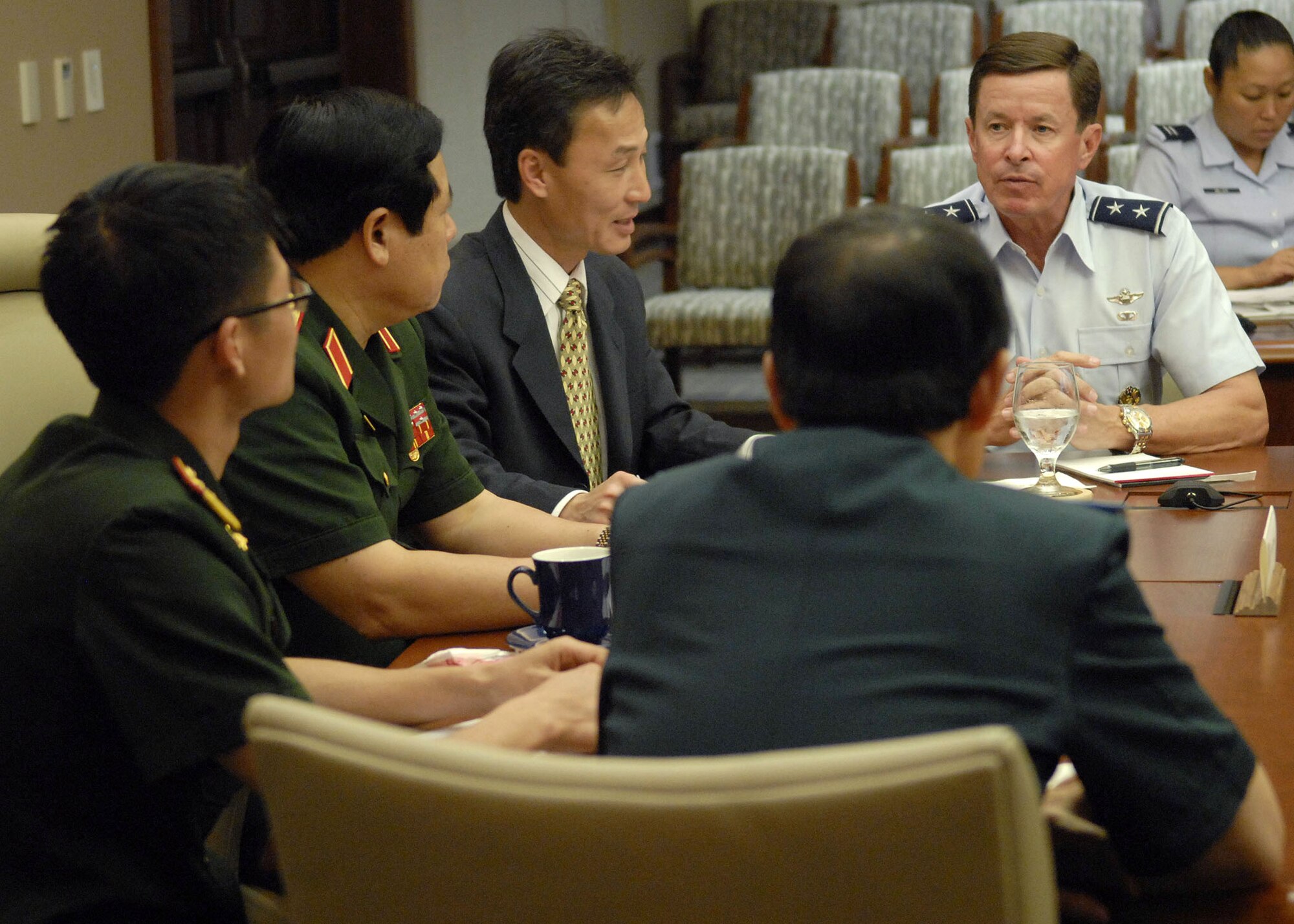 Maj. Gen David L. Commons, Mobilization Assistant, to the Pacific Air Forces, commander, briefs, Vietnamese, Minister of Defense, Gen. Phung Quang Thanh, and Lt. Gen. Nguyen Quoc Khanh, Deputy Chief of the General's Staff, during an office call to explain, PACAF's mission throughout its area of responsibility, at the Falcon Conference Room, headquarters, PACAF building, during a tour of Hickam Air Force Base, Hawaii, on Dec. 11. Gen. Phung Quang Thanh was accompanied by a delegation of 13 members, which consisted of both Vietnamese Army and Navy personnel. (U.S. Air Force photo/Tech. Sgt. Jerome S. Tayborn)