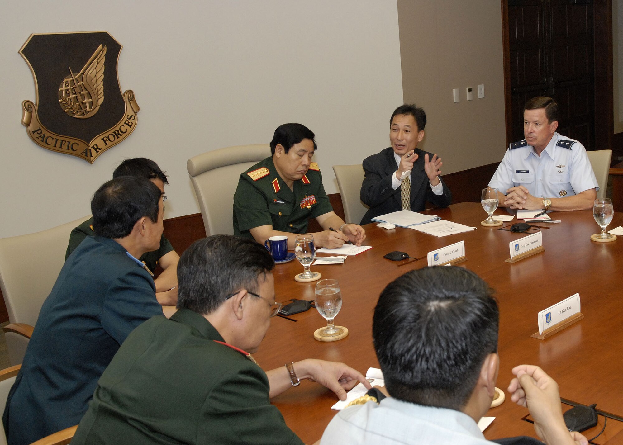 Maj. Gen David L. Commons, Mobilization Assistant, to the Pacific Air Forces, commander, briefs, Vietnamese, Minister of Defense, Gen. Phung Quang Thanh, and his delegation, during an office call to explain, PACAF's mission throughout its area of responsibility, at the Falcon Conference Room, headquarters, PACAF building, during a tour of Hickam Air Force Base, Hawaii, on Dec. 11. Gen. Phung Quang Thanh was accompanied by a delegation of 13 members, which consisted of both Vietnamese Army and Navy personnel. (U.S. Air Force photo/Tech. Sgt. Jerome S. Tayborn)