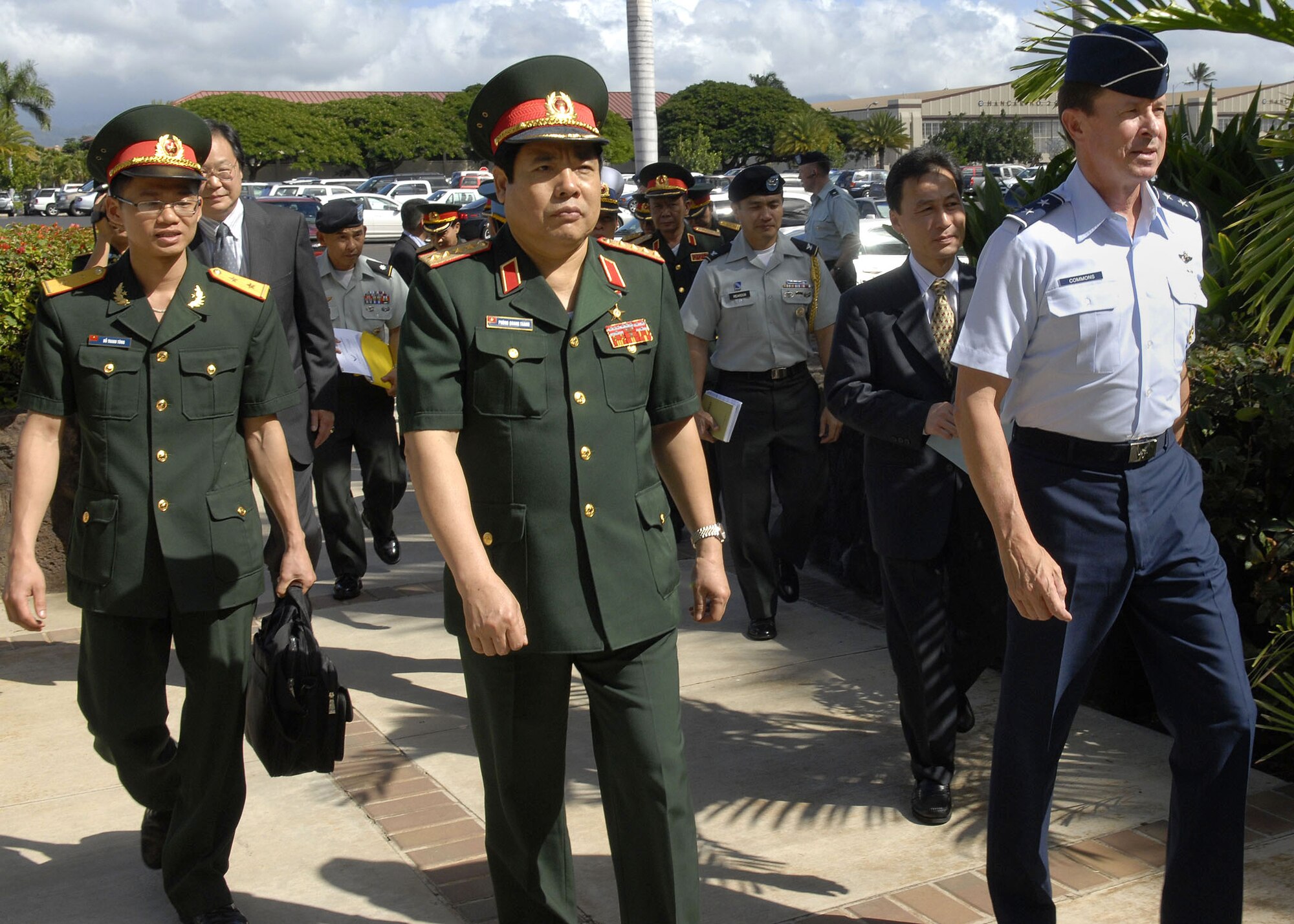 Maj. Gen David L. Commons, Mobilization Assistant, to the Pacific Air Forces, commander, escorts Vietnamese, Minister of Defense, Gen. Phung Quang Thanh, and his delegation, into the headquarters, PACAF building, during a tour of Hickam Air Force Base, Hawaii, on Dec. 11.  Gen. Phung Quang Thanh was accompanied by a delegation of 13 members, which consisted of both Vietnamese Army and Navy personnel. (U.S. Air Force photo/Tech. Sgt. Jerome S. Tayborn)