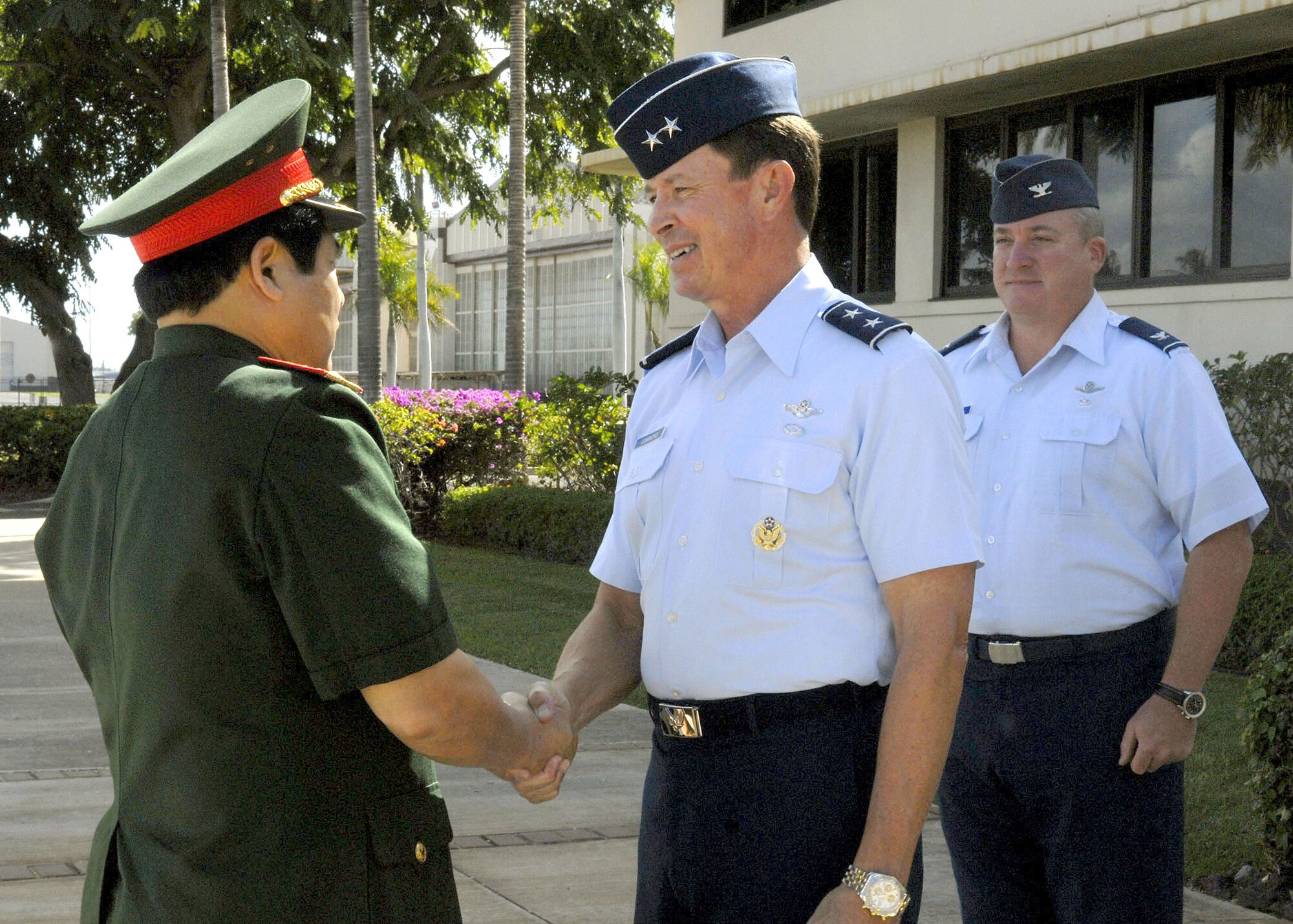 Maj. Gen David L. Commons, Mobilization Assistant, to the Pacific Air Forces, commander, and Col. Bradley Hammer, International Affairs Division, Pacific Air Forces, greet Vietnamese, Minister of Defense, Gen. Phung Quang Thanh, at headquarters, PACAF, during a tour of Hickam Air Force Base, Hawaii, on Dec. 11.  Gen. Phung Quang Thanh was accompanied by a delegation of 13 members, which consisted of both Vietnamese Army and Navy personnel. (U.S. Air Force photo/Tech. Sgt. Jerome S. Tayborn)