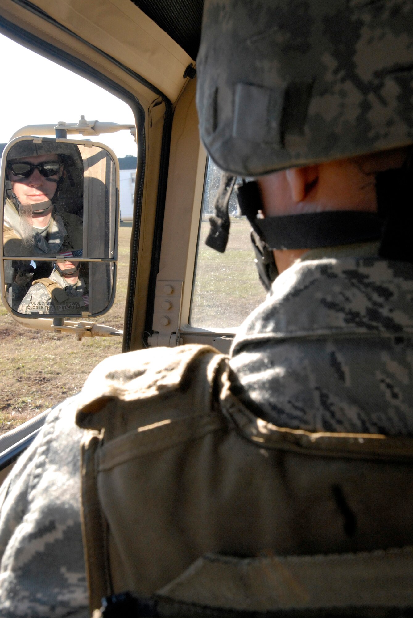 Tech. Sgt. Brad Mitchellpeers into the rear view mirror of a Humvee as he begins a reconnaissance exercise Dec. 10, 2009, at Fort Pickett, Va. The training was part of Patriot 7, a week-long exercise using intelligence,
surveillance and reconnaissance to support irregular warfare missions. Sergeant Mitchell is a 342nd Training Squadron Basic Combat Convoy Course instructor. (U.S. Air Force photo/Tech. Sgt. Amaani Lyle)