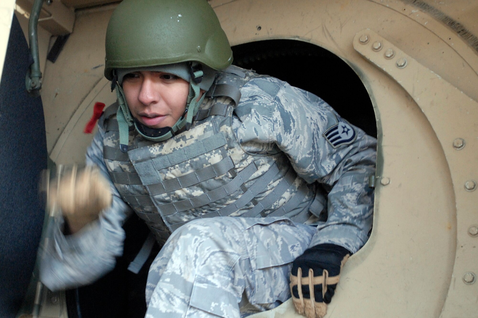 Staff Sgt. Rene Trevino participates in Humvee egress assistance training Dec. 10, 2009 during Patriot 7, a week-long exercise using intelligence, surveillance and reconnaissance to support irregular
warfare missions at Fort Pickett, Va. After a simulated 180-degree Humvee rollover, students
scrambled to safely exit the vehicle. About 30 Air Force, joint and coalition trainees conducted integrated sensor, aircraft and counterterrorism training to learn how to make more dynamic decisions on the
battlefield. Sergeant Trevino is a 11th Security Forces Squadron desk sergeant. (U.S. Air Force photo/Tech. Sgt. Amaani Lyle)