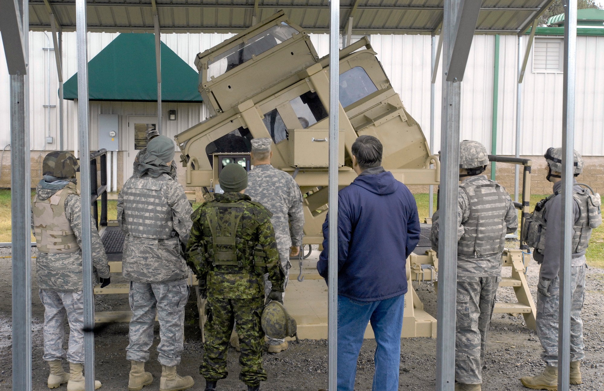 Students and instructors observe fellow trainees withstand 45-, 90- and 180-degree simulated rollovers in a Humvee body connected to a motorized rotating system here Dec. 10, 2009, at Fort Pickett, Va.
The training was part of Patriot 7, a week-long exercise using intelligence, surveillance and reconnaissance to support irregular warfare missions. Students also participated in a variety of training to include Humvee egress assistance training and a convoy mission exercise. (U.S. Air Force photo/Tech. Sgt. Amaani Lyle)
