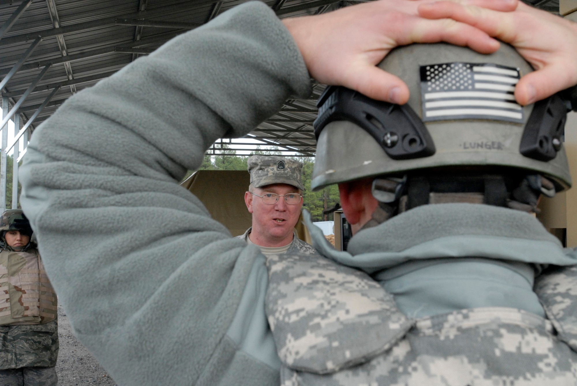 (Foreground) Staff Sgt. Brian Lunger listens to Army Staff Sgt. Michael Cowan provide feedback during Humvee egress assistance training Dec. 10, 2009 at Fort Pickett. The training was part of Patriot 7, a week-long exercise using intelligence, surveillance and reconnaissance to support irregular warfare missions. Sergeant Lunger is from the 21st Security Forces Squadron. (U.S. Air Force photo/Tech. Sgt. Amaani Lyle)
