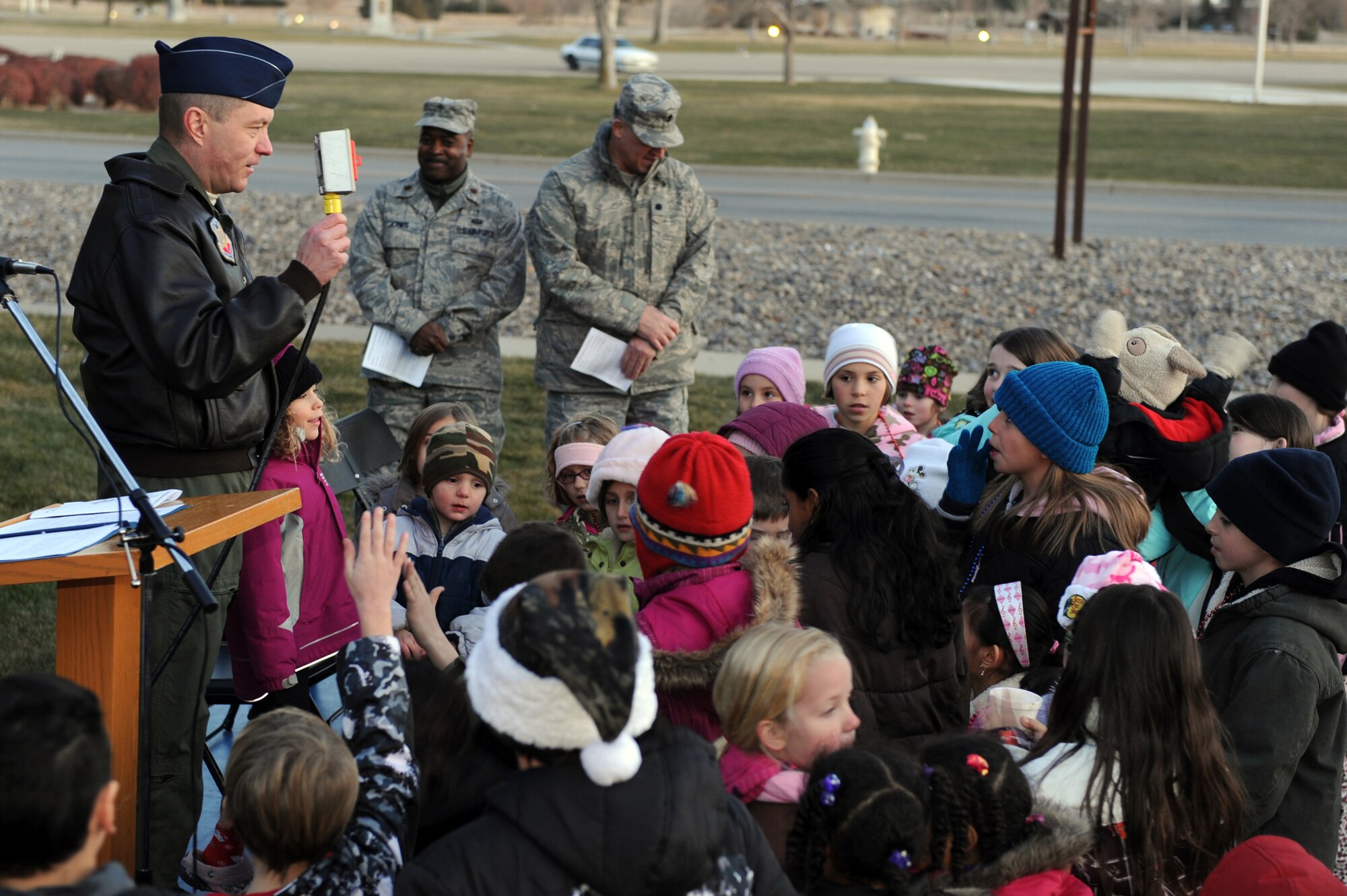 MOUNTAIN HOME AIR FORCE BASE, Idaho -- Col. Pete Lee, 366th Fighter Wing vice commander,  invites children up to help push the button to  light the Christmas tree during the annual ceremony Dec. 4 at the base chapel. The First Sergeants Association and base chapel teamed up to put together a holiday parade followed by a Christmas tree lighting ceremony. (U.S. Air Force photo by Master Sgt. Tim Cook)