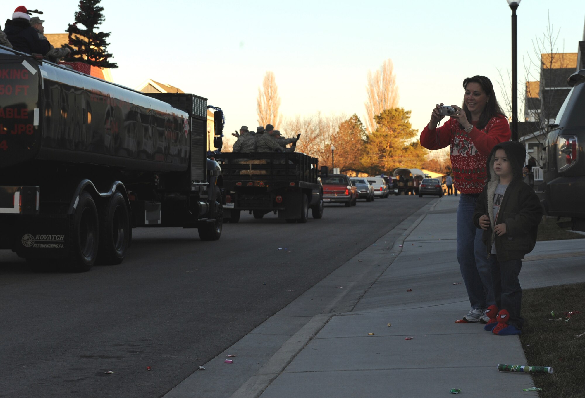 MOUNTAIN HOME AIR FORCE BASE, Idaho -- Base housing residents come outside to take pictures and watch as a holiday parade passes by Dec. 4. The First Sergeants Association and base chapel teamed up to put together a holiday parade followed by a Christmas tree lighting ceremony at the base chapel. (U.S. Air Force photo by Master Sgt. Tim Cook)
