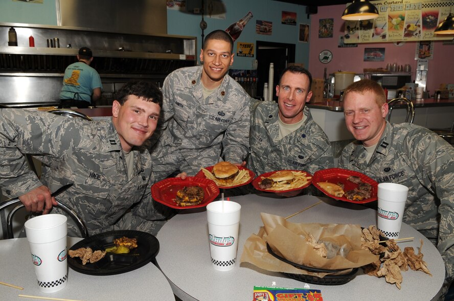 Capt. Timothy Hade, 4th Comptroller Squadron deputy budget officer, Maj. Anthony Smith, 4th Comptroller Squadron commander, Lt. Col. Michael Vecera, 4th Fighter Wing staff judge advocate, and Capt. Jeremy Gehman, 4th Fighter Wing chief of general law, pose for a group photo after the "Big 'A' Challenge" at Andy's Cheesesteaks and Cheeseburgers in Goldsboro, N.C., Dec. 15, 2009. The four officers participated in a friendly lunchtime competition to determine who could eat a 50-ounce stack of cheeseburgers, fries and a 24-ounce beverage within 30 minutes. Capt. Hade is originally from Franklin Lakes, N.J., Maj. Smith is originally from Vincenza, Italy, Col. Vecera is a Baltimore native, and Capt. Gehman hails from Pensacola, Fla. (U.S. Air Force photo/Staff Sgt. Courtney Richardson)