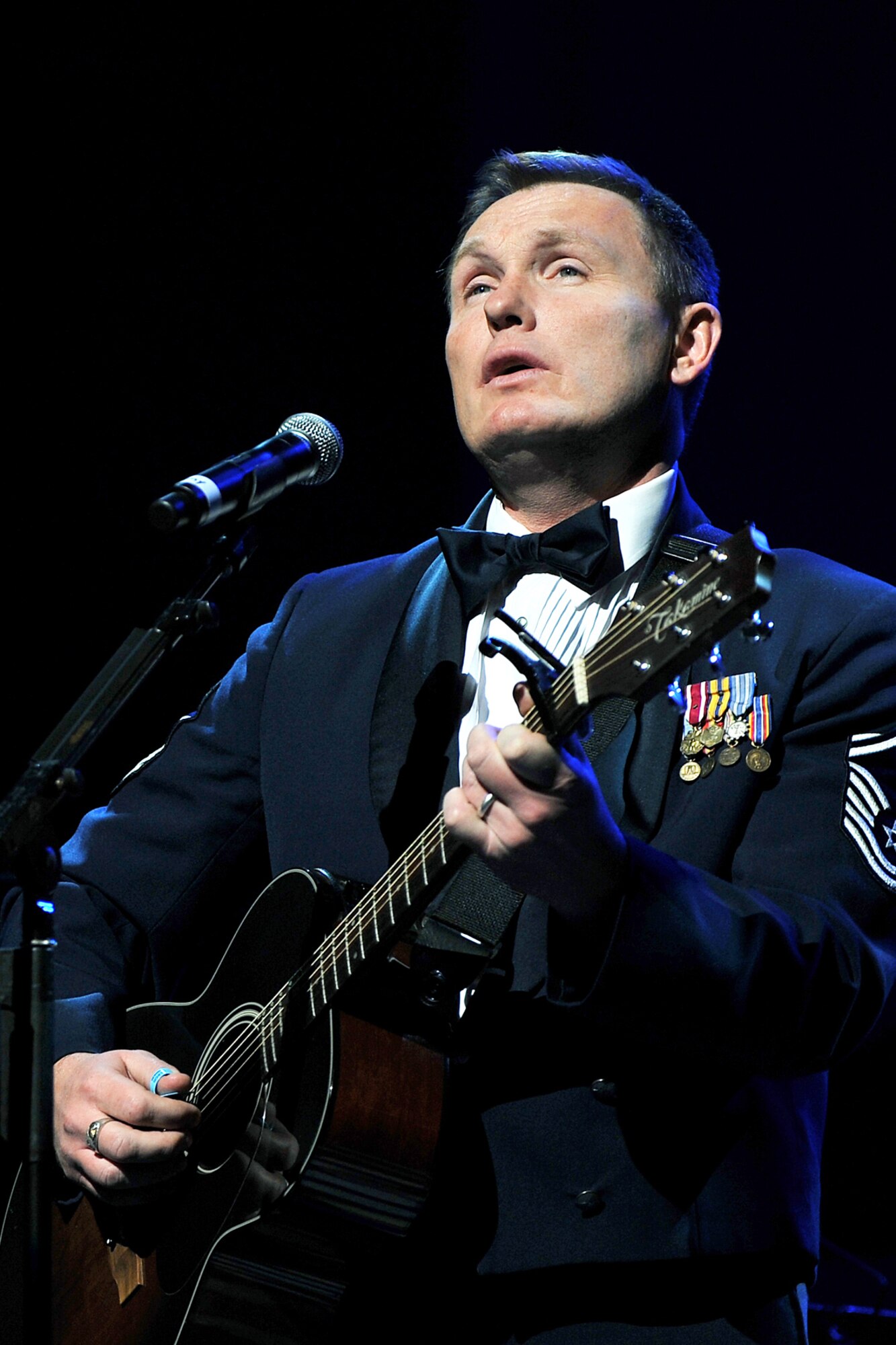 OFFUTT AIR FORCE BASE, Neb. ? Senior Master Sgt. Jimmy Weber, superintendent of the Heartland of America Band, sings ?O Holy Night? during the band?s ?Here Come the Holidays? concert at Omaha?s Holland Performing Arts Center Dec. 10. The annual concert series consisted of six concerts over four days. 

U.S.  Air Force Photo by Charles Haymond
