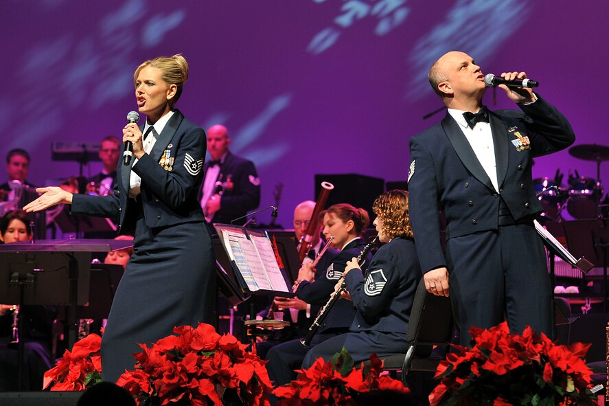 OFFUTT AIR FORCE BASE, Neb. -- Tech. Sgt. Lara Murdzia and Tech. Sgt. Kenneth Maxwell, both vocalists with the Heartland of America Band, sing ?Joy to the World? during the band?s ?Here Come the Holidays? concert at Omaha?s Holland Performing Arts Center Dec. 10. The annual concert series consisted of six concerts over four days.  U.S. Air Force Photo by Charles Haymond