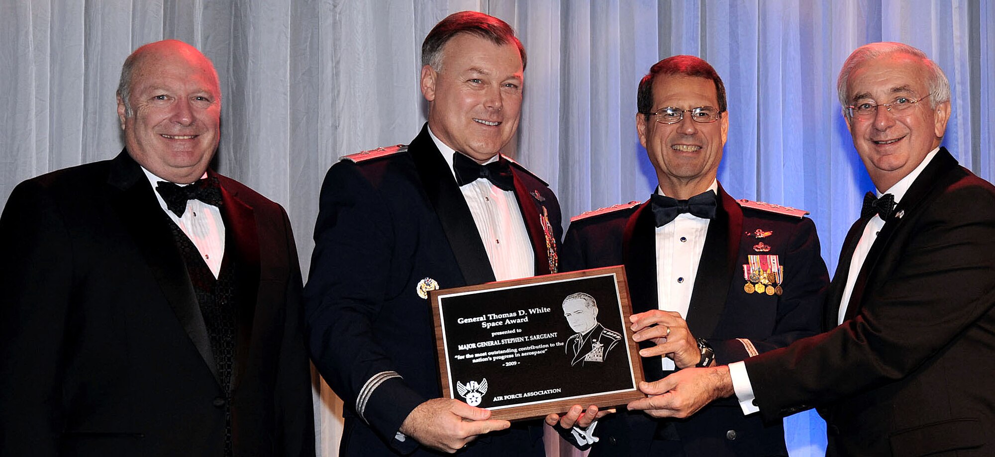 From left are retired Maj. Gen. Thomas Taverney, Air Force Association?s General Schriever Los Angeles Chapter president; Maj. Gen. Stephen Sargeant, Air Force Operational Test and Evaluation Center commander; Gen. John Sheridan, Space and Missile System Center commander; and Joseph Sutter, Air Force Association Board chairman. General Sargeant received the 2009 Gen. Thomas D. White U.S. Air Force Space Trophy in this joint presentation. U.S. Air Force photo by Lou Hernandez