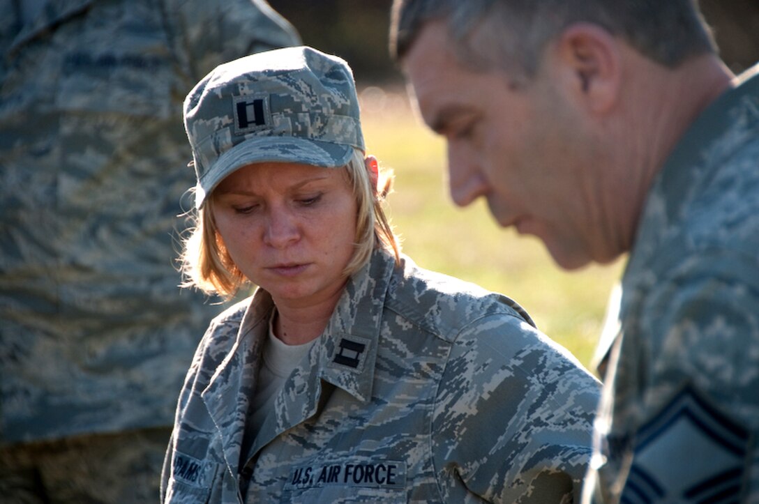 Captain Angel Adams, 139th Airlift Wing, looks on as a Senior Master Sgt. explains details of a search and recovery exercise on Wednesday, Nov 4, 2009 in St. Joseph, Mo.  (US Air Foce photo by MSgt. Shannon Bond) (Released)