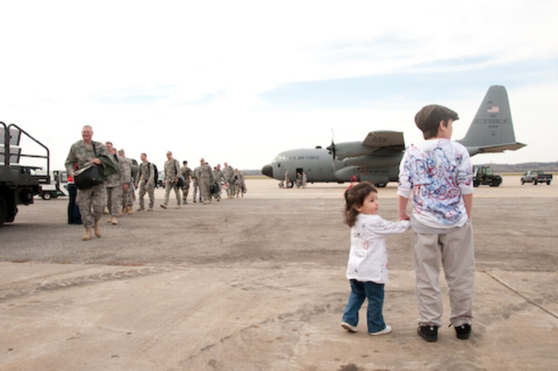 Guard members and families of the 139th Airlift Wing, Security Forces Squadron, wait for their colleagues s and loved ones as they return from a one year deployment on Friday, November 6, 2009. (US Air Force photo by MSgt. Shannon Bond) (RELEASED)