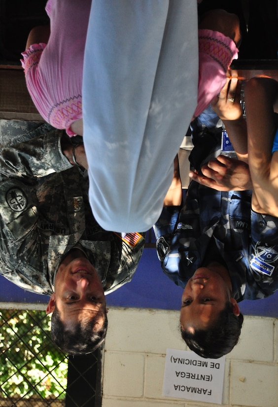 U.S. Army Maj. (Dr.) David Haight and a representative of the El Salvador military explain dosing instructions to a woman who received medical treatment in El Achiotal, El Salvador, Dec. 15, 2009. The woman was one of more than 1,300 patients seen during a two-day medical mission offering residents affected by November flooding and mudslides the opportunity to receive medical care, immunizations, education, and prescription drugs free of charge. It was a combined effort between the Salvadoran government, the U.S. Embassy in El Salvador, and U.S. Southern Command’s Joint Task Force-Bravo – based at Soto Cano Air Base, Honduras.