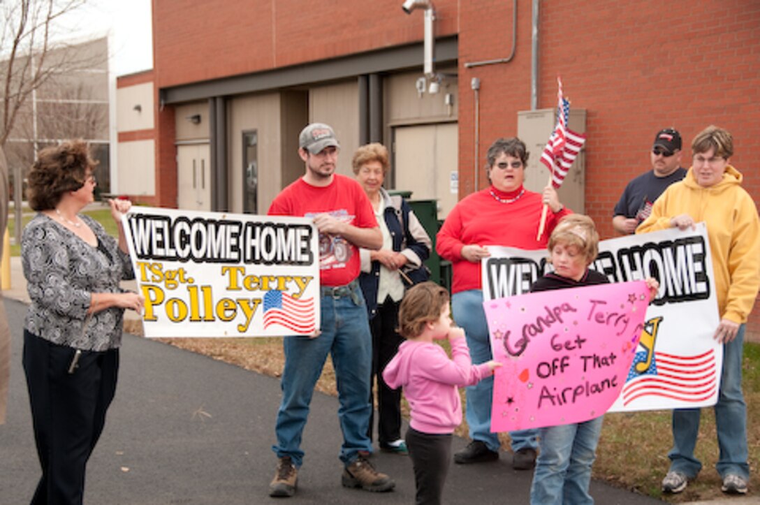 Families of the 139th Airlift Wing, Security Forces Squadron, wait for their loved ones as they return from a one year deployment on Friday, November 6, 2009. (US Air Force photo by MSgt. Shannon Bond) (RELEASED)