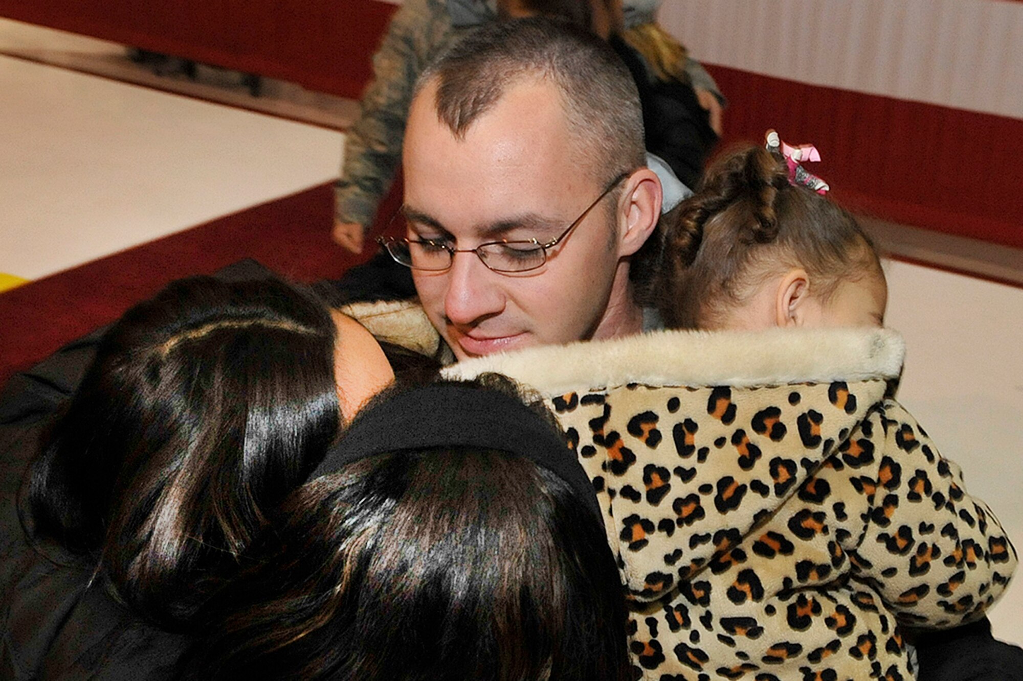 An Airman from the 17th Expeditionary Space Control Squadron reunites with his family members early in the frigid morning Dec. 9.
About 30 Airmen from the 17th ESPCS arrived at Peterson Air Force Base from supporting overseas contingency operations. The Airmen, all part of the 21st Space Wing, were engaged in delivering needed space control capabilities to rapidly achieve key combatant commander objectives. 
Col. Stephen N. Whiting, 21st Space Wing commander, welcomed and thanked the returning servicemembers and their families for the sacrifices made during their separation, and Brig. Gen. Dave Warner, Air Force Space Command director of Communications and Information, offered a heartfelt welcome and thank you to the warriors. 
“While we celebrate their successful accomplishments and safe arrival home, especially so close to the holidays, we must continue to remember those who made the ultimate sacrifice and those who remain abroad defending our freedom during this upcoming holiday celebration,” Colonel Whiting said.