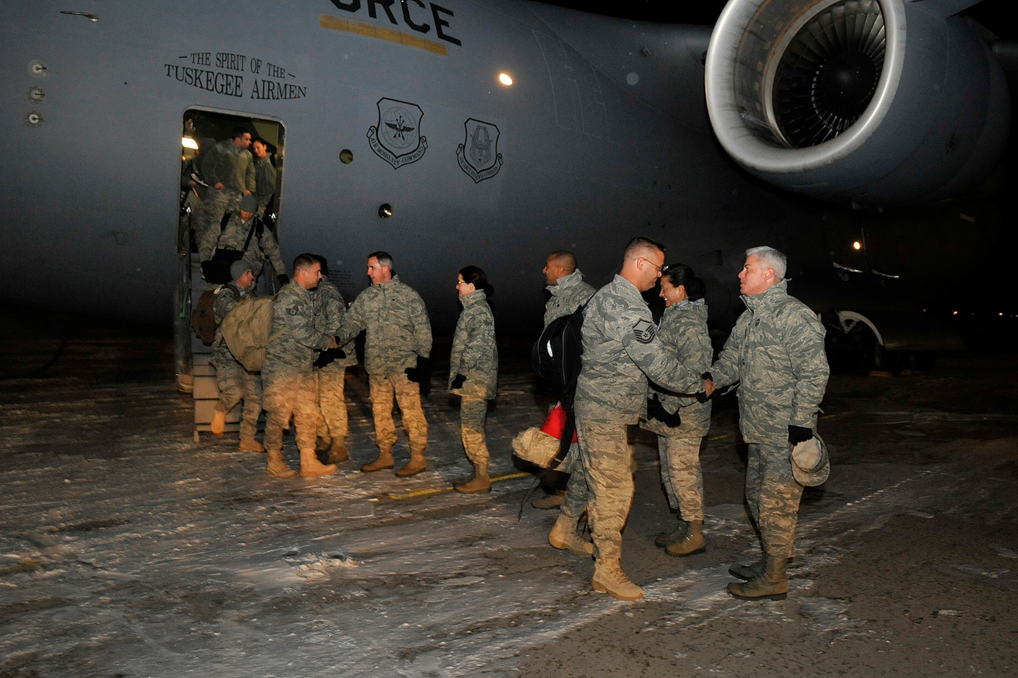 About 30 Airmen from the 17th Expeditionary Space Control Squadron returned to Peterson Air Force Base from supporting overseas contingency operations early in the frigid morning Dec. 9. The Airmen, all part of the 21st Space Wing, were engaged in delivering needed space control capabilities to rapidly achieve key combatant commander objectives. 
Col. Stephen N. Whiting, 21st Space Wing commander, welcomed and thanked the returning servicemembers and their families for the sacrifices made during their separation, and Brig. Gen. Dave Warner, Air Force Space Command director of Communications and Information, offered a heartfelt welcome and thank you to the warriors. 
“While we celebrate their successful accomplishments and safe arrival home, especially so close to the holidays, we must continue to remember those who made the ultimate sacrifice and those who remain abroad defending our freedom during this upcoming holiday celebration,” Colonel Whiting said.
The warriors represented the first of three expeditionary space control squadrons deployed by the Wing, flawlessly executing key space effects across various areas of responsibility. (Air Force photo by Rob Bussard)