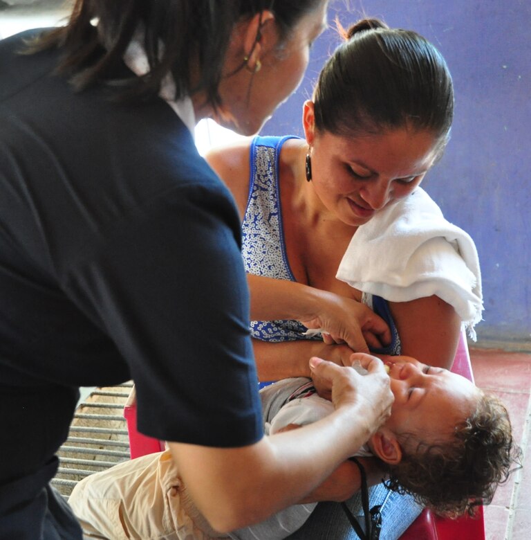 A representative of the Salvadoran Ministry of Health administers anti-parasitic medication to a young boy as his mother holds the child during a Medical Civil Action Program (MEDCAP) here. The boy was one of more than 1,300 patients seen during a two-day medical mission offering residents affected by November flooding and mudslides the opportunity to receive medical care, immunizations, education, and prescription drugs free of charge. It was a combined effort between the Salvadoran government, the U.S. Embassy in El Salvador, and U.S. Southern Command’s Joint Task Force-Bravo – based at Soto Cano Air Base, Honduras. (U.S. Air Force photo/Tech. Sgt. Mike Hammond)