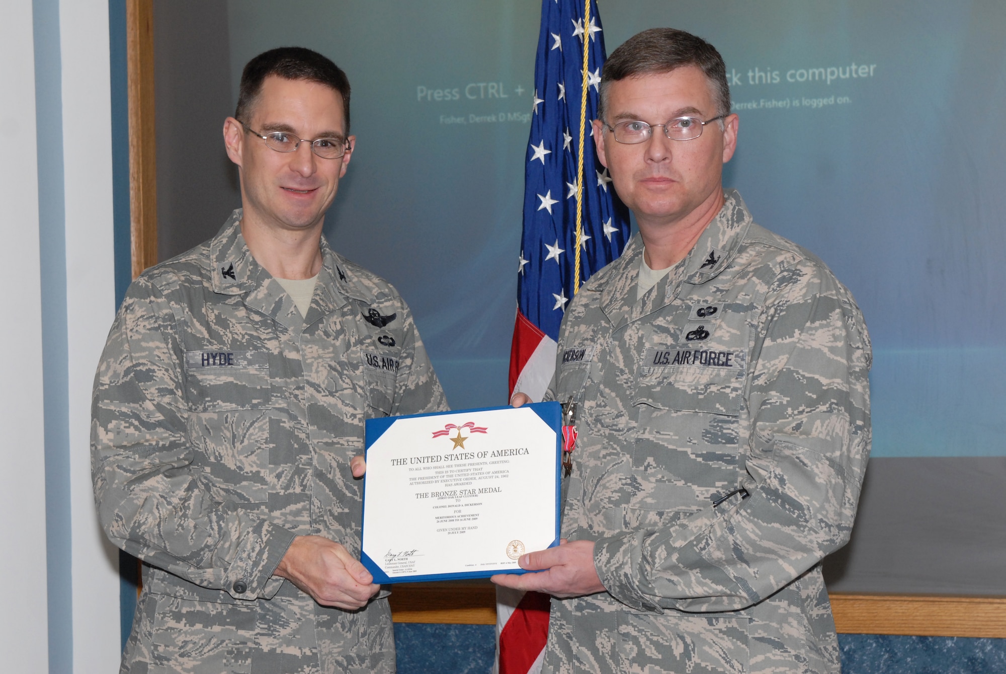 Col. C. K. Hyde, 314th Airlift Wing commander, awards Col. Adam Dickerson, 314th Maintenance Group commander, with a bronze star medal Dec. 15. Colonel Dickerson distinguished himself while engaged in ground and air operations during his deployment to a base in Southwest Asia. The colonel led a multi-discipline, 21-member team which engaged the agencies of the host-nation government on mission-essential issues affecting all United States forces deployed to, or transitioning through, the host country he was stationed at in direct support of Operations Enduring and Iraqi Freedom, and Combined Joint Task Force-Horn of Africa. (U.S. Air Force Photo by Senior Airman Christine Clark)