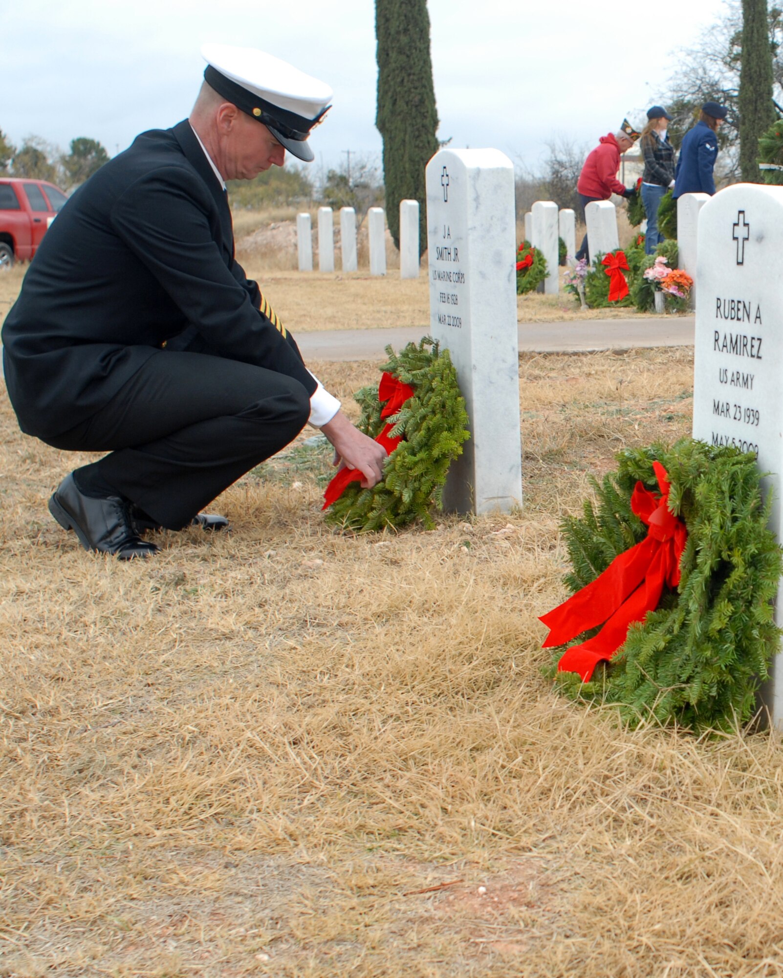 SAN ANGELO, Texas -- Navy Master Chief Petty Officer Paul Zimmerman, Center for Information Dominance Detachment, lays a wreath on a veteran's grave during the Civil Air Patrol's annual Wreaths Across America event at Belvedere Memorial Park, Dec. 12, 2009. This event honors the courage and sacrifice of veterans of the Armed Forces and the Merchant Marine. (U.S. Air Force photo/Staff Sgt. Laura R. McFarlane)
