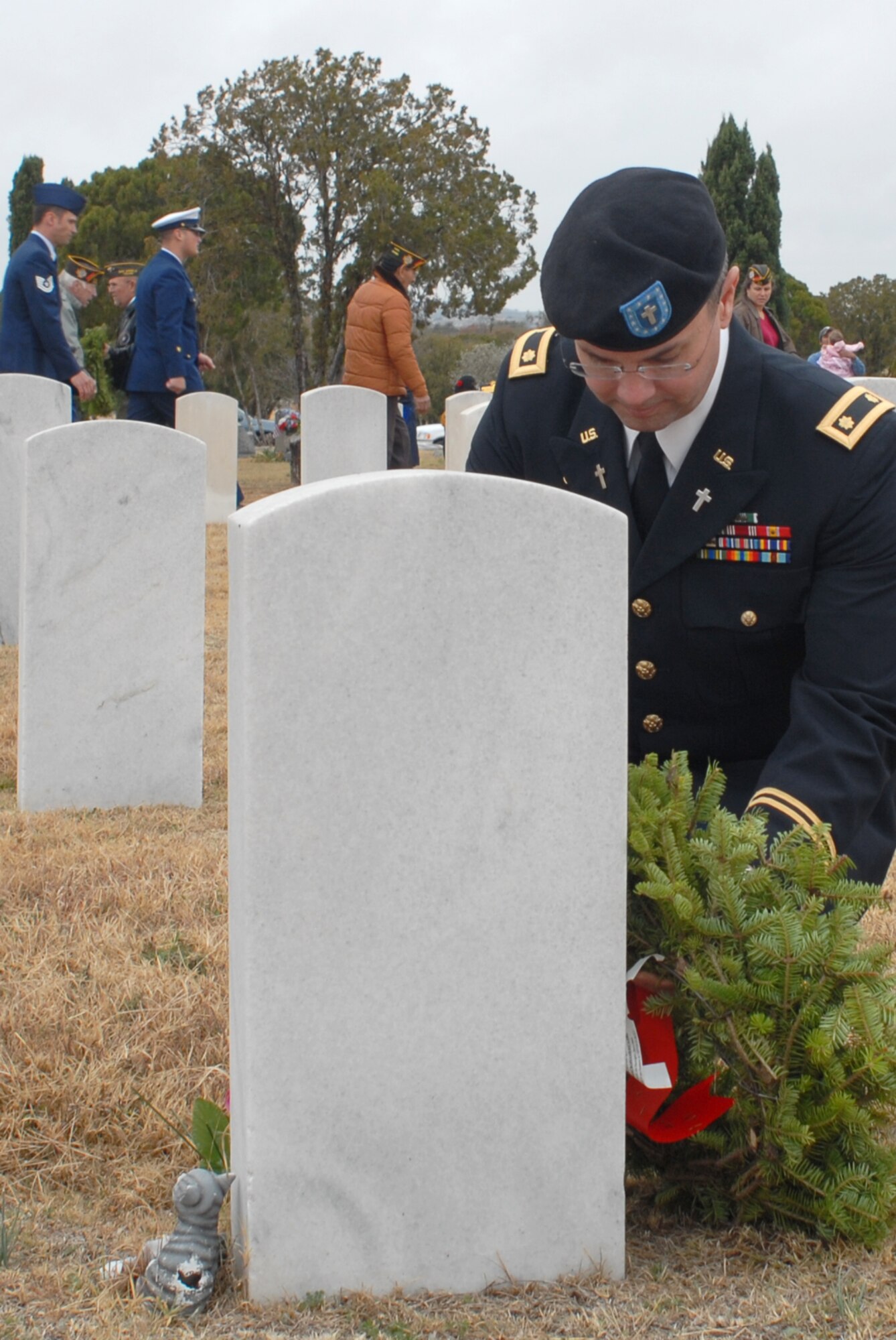 SAN ANGELO, Texas -- Army Chaplain (Maj.) Michael McDonald, 344th Military Intelligence Battalion, lays a wreath on a veteran's grave during the Civil Air Patrol's annual Wreaths Across America event at Belvedere Memorial Park, Dec. 12, 2009. This event honors the courage and sacrifice of veterans of the Armed Forces and the Merchant Marine. (U.S. Air Force photo/Staff Sgt. Laura R. McFarlane)
