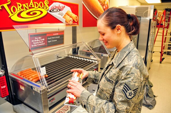 U.S. Air Force Staff Sgt. Stephanie Clark, 914th Airlift Wing, enjoys the new selections at the Base Exchange (BX), December 15, 2009, Niagara Falls Air Reserve Station, NY. The BX now has hot dogs and coffee available during the day as part of an expansion of services available to those serving at the Niagara Falls Reserve Station.  (U.S. Air Force photo by Staff Sgt. Joseph McKee)