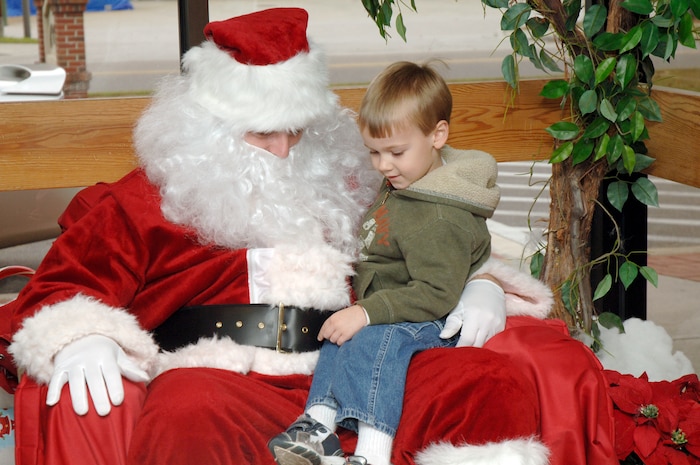 Noah Grove sits on Santa's lap and tells him what he wants for Christmas during the youth holiday party at the Youth Programs Center here Dec. 12, 2009. Charleston Air Force Base youths had the opportunity to play games, decorate cupcakes, scale a wall, sit on Santa's lap and enjoy arts and crafts during the annual holiday party. Noah is the son of Gary Grove who is with the 437th Force Support Squadron. (U.S. Air Force photo/Staff Sgt. Marie Brown)