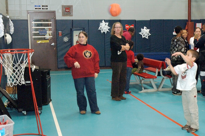 Alex Serrano throws a basketball for a prize during the youth holiday party at the Youth Programs Center here Dec. 12, 2009. Charleston Air Force Base youths had the opportunity to play games, decorate cupcakes, scale a wall, sit on Santa's lap and enjoy arts and crafts during the annual holiday party. Alex is the son of U.S. Air Force Staff Sgt. Kevin Serrano who is with the 437th Logistics Readiness Squadron. (U.S. Air Force photo/Staff Sgt. Marie Brown)