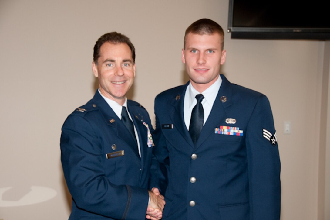 Colonel Michael McEnulty, 139th Airlift Wing commander, congratulates an Airman of the year winner on November 7, 2009 at Rosecrans in St. Joseph Missouri. The competition is held annually and the winners from the wing go on to compete at the state leve. (U.S. Air Force photo by Staff Sgt. Michael Crane) (RELEASED)