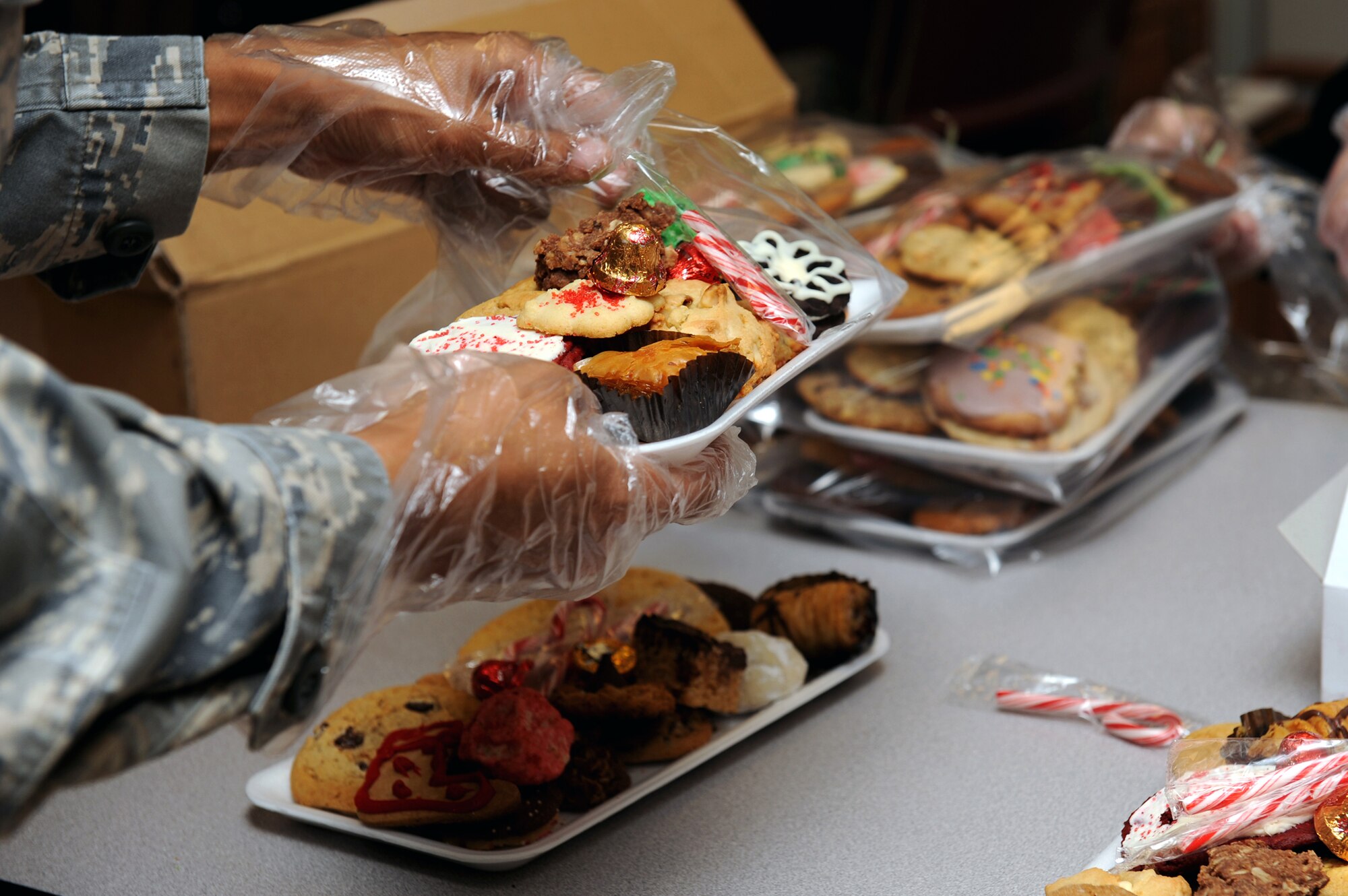 NELLIS AIR FORCE BASE, Nev.-- Airman 1st Class Latricia Joyce, Nellis AFB Honor Guardsman, helps pack cookies during the Annual Cookie Drive, Dec. 14.  The cookie drive is held during the holidays for single Airmen living in the dorms.
(U.S. Air Force photo by Airman 1st Class Brett Clashman)
