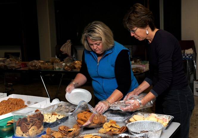 NELLIS AIR FORCE BASE, Nev.--  Victoria McLaughlin, wife of Brig. Gen. Kevin McLaughlin, and Lorrie Kresge, wife of Maj. Gen. Ted Kresge, prepare cookies to be packed during the Annual Cookie Drive, Dec. 14.  The cookie drive is held during the holidays for single Airmen living in the dorms.
(U.S. Air Force photo by Airman 1st Class Brett Clashman)