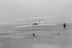 Orville Wright at the controls of the 1903 Wright Flyer during the first successful powered flight Dec. 17, 1903 at Kittyhawk, N.C., while Wilbur Wright looks on. The first flight at 10:35 a.m. was 120 feet and lasted 12 seconds. The 106th anniversary of the event will be celebrated Dec. 17, 2009 at the Wright Brothers Memorial, Wright-Patterson Air Force Base, Ohio. Today, visitors to Wright-Patt and the Dayton region can learn about the Wright Brothers at the Dayton Aviation Heritage National Historical Park.  (Library of Congress) 