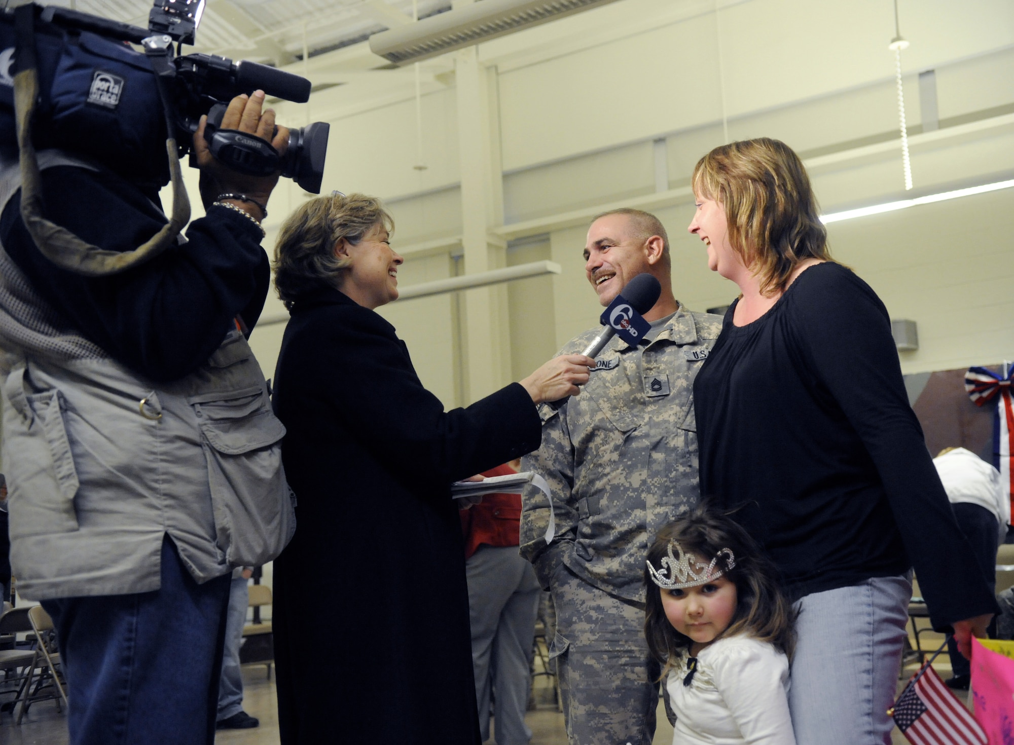 Videographer for Channel 6 Action News, left, films newsreporter Nora Muchanic's interview with Sgt.1st Class Michael Culmone, Pennsylvania Army National Guard, 628th Aviation Support Battalion, wife, Bettina and daughter Alissa, Dec.8.
The 628th ASB is returning home from a nine-month deployment. (U.S. Air Force Photo/Carlos Cintron)

