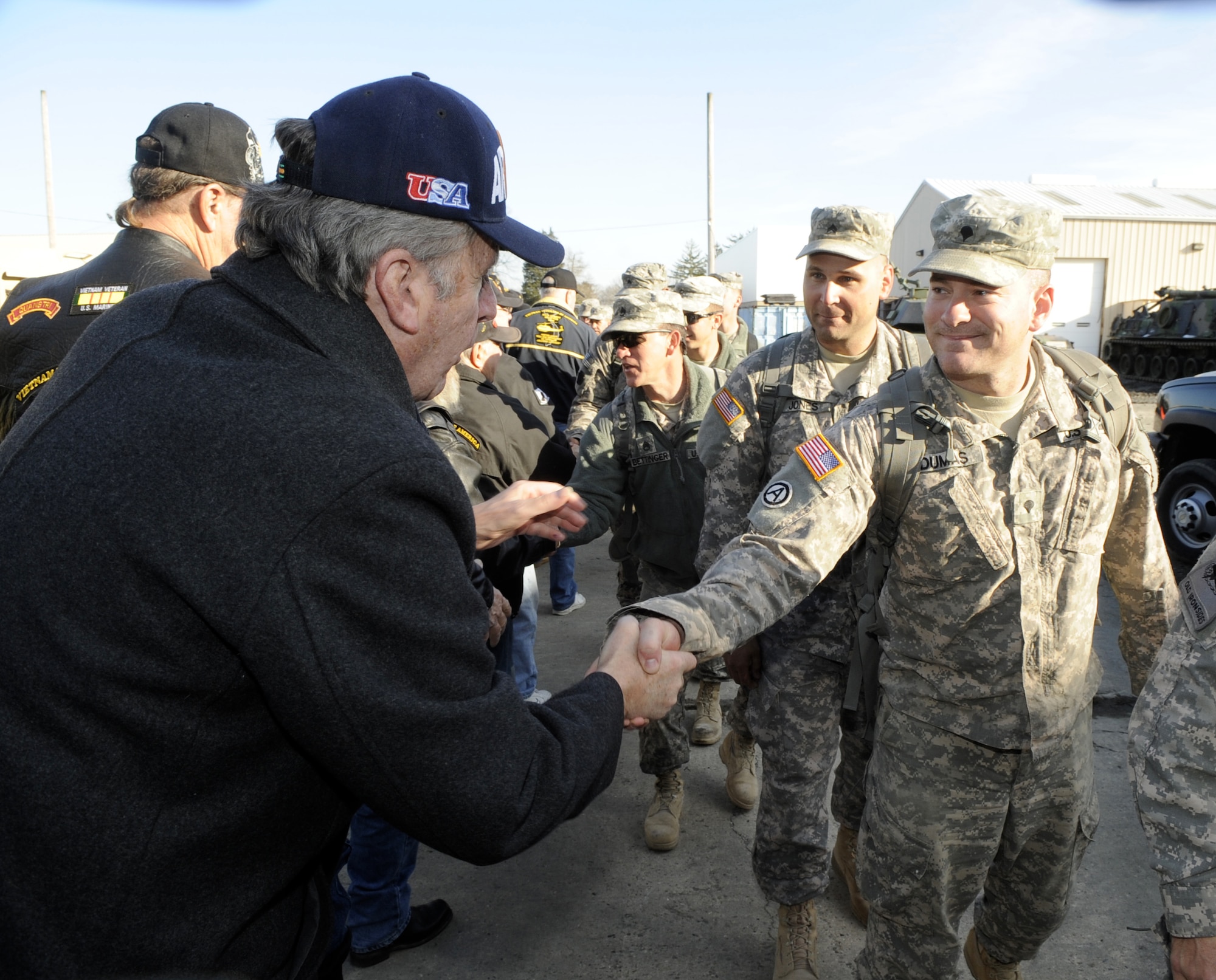 Soldiers from the Pennsylvania Army National Guard 628th Aviation Support Battalion, right, receive a welcome home handshake from members of the Vietnam Veterans of America Chapter 899 from Bordentown, Dec. 8.
The Soldiers are returning home after a nine month deployment.  (U.S. Air Force Photo/Carlos Cintron)
