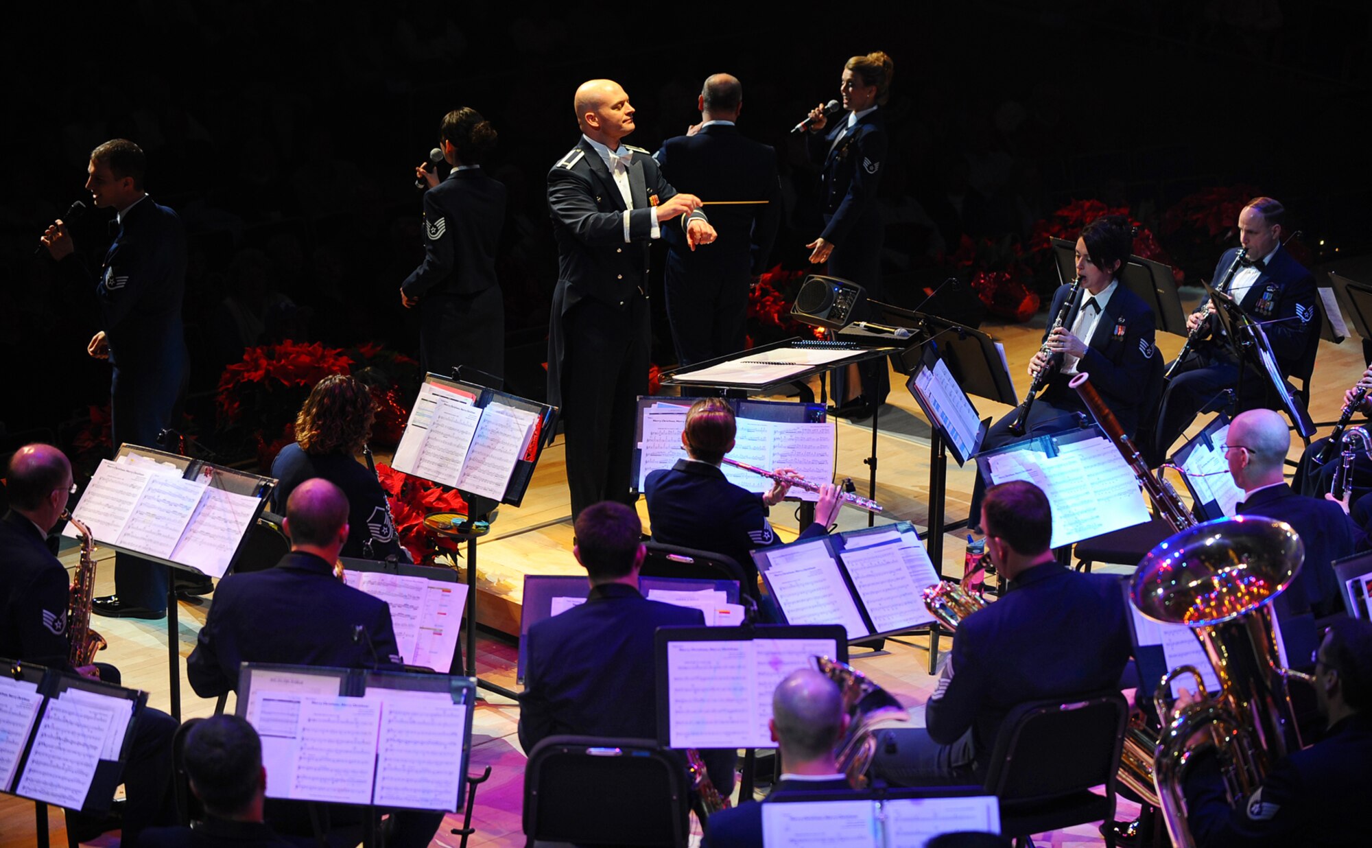 OFFUTT AIR FORCE BASE, Neb.- 1st Lt. Michael D. Hoerber, commander of the Heartland of America Band, condcuts the group's concert ensemble during the band's "Here Come the Holidays" concert at the Holland Performing Arts Center Dec. 10 in Omaha, Neb. The annual concert series consisted of six concerts over four days. U.S. Air Force Photo by Josh Plueger