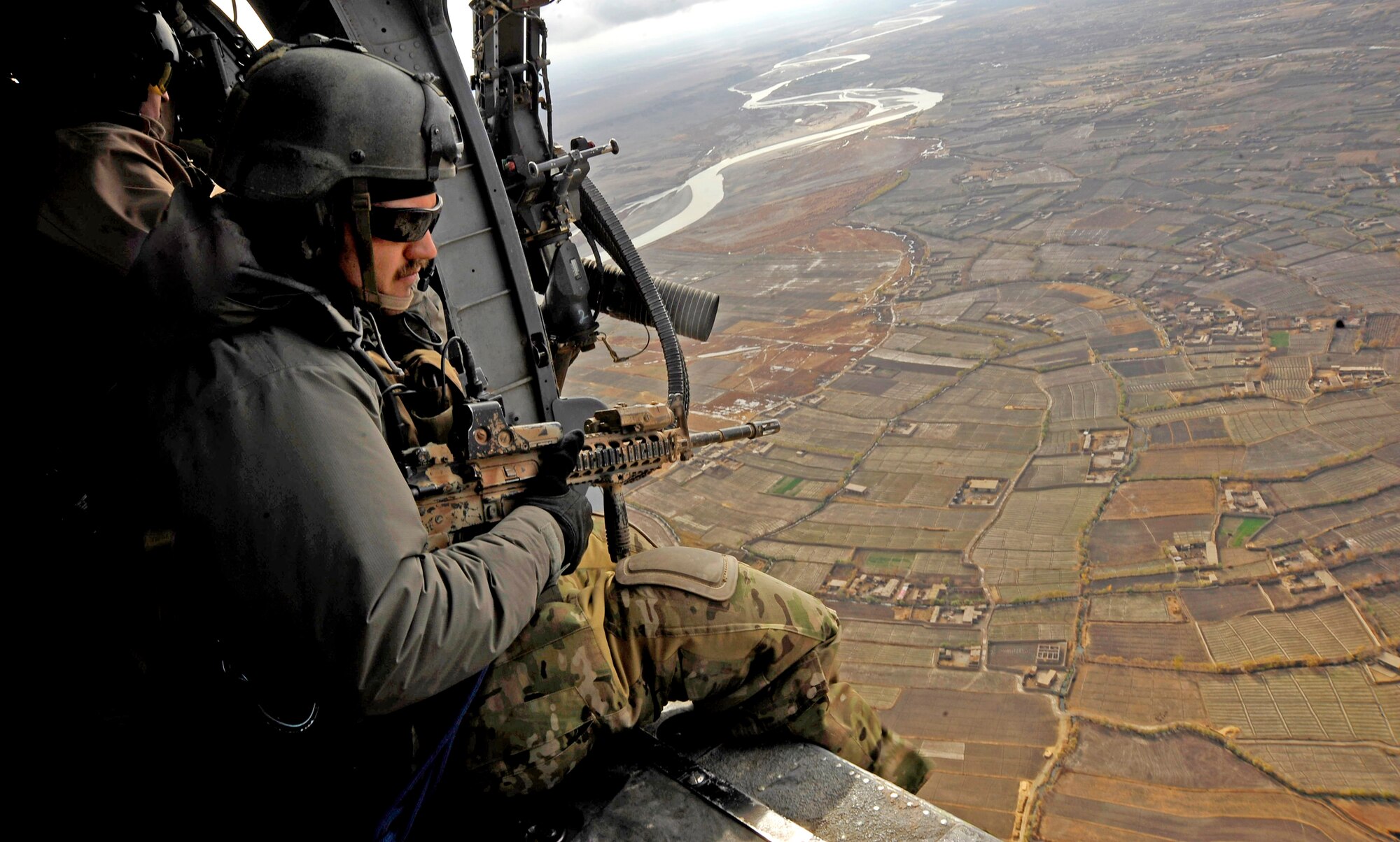 A pararescueman provides area security while another HH-60G Pave Hawk is picking up a patient Dec. 8, 2009. The members of the 66th Expeditionary Rescue Squadron can respond to medical evacuations in less than seven minutes to pick up patients in need of care. The pararescueman is assigned to the 66th Expeditionary Rescue Squadron. (U.S. Air Force photo/Staff Sgt. Angelita Lawrence) 