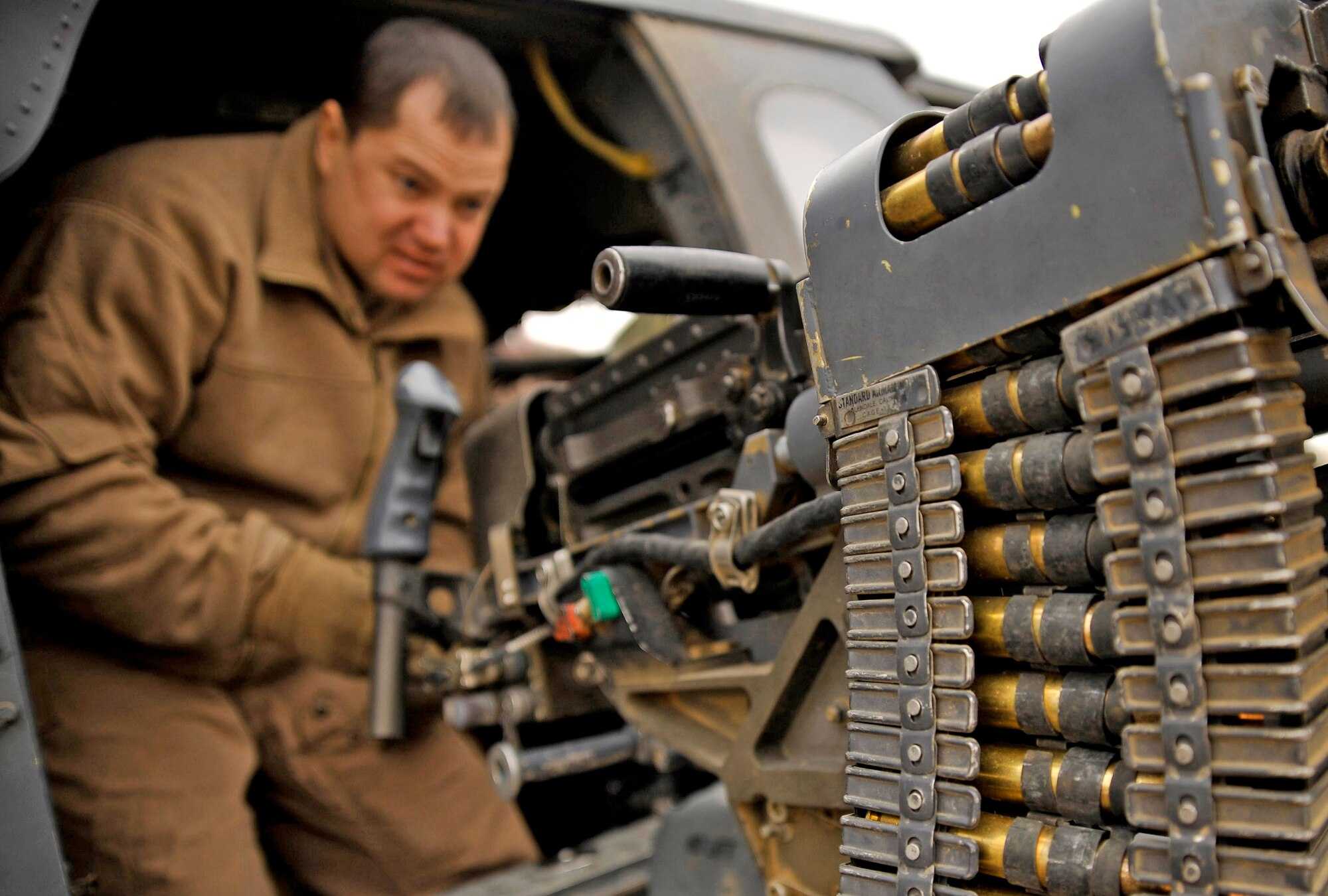 Master Sgt. Don Ballowe inspects his 50-caliber machine gun Dec. 8, 2009 at Camp Bastion, Afghanistan. While the crew pre-loads the aircraft, they also inspect their equipment to ensure it is properly working before a rescue mission. Sergeant Ballowe is a 66th Expeditionary Rescue Squadron flight engineer. (U.S. Air Force photo/Staff Sgt. Angelita Lawrence)