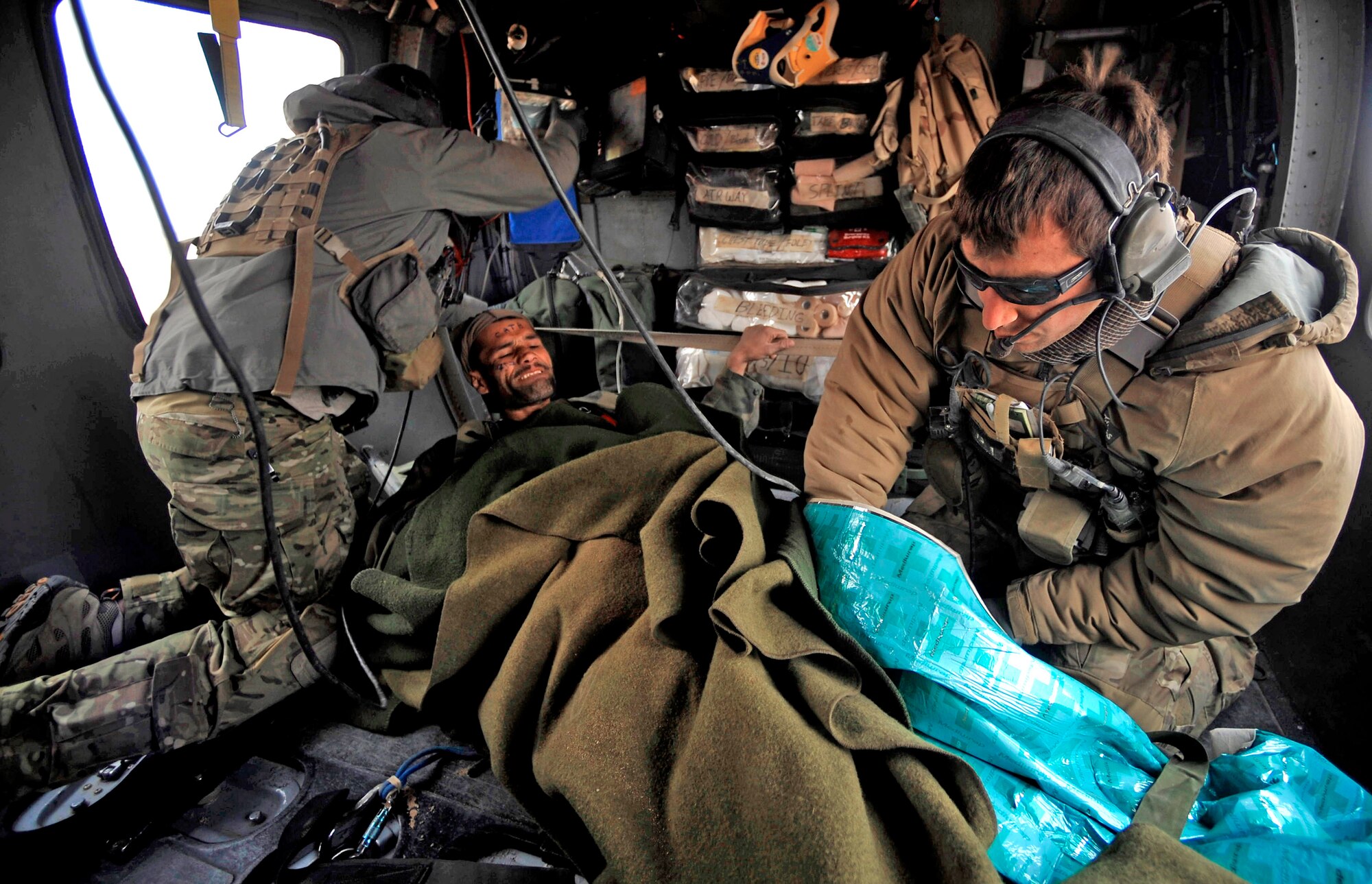 Pararescuemen provide medical attention to an Afghan who has suffered gunshot injuries, Dec. 08, 2009. The pararescuemen are able to rescue patients in any situation who need medical attention. The pararescuemen are assigned to the 66th Expeditionary Rescue Squadron deployed to Camp Bastion, Afghanistan. (U.S. Air Force photo/Staff Sgt. Angelita Lawrence)