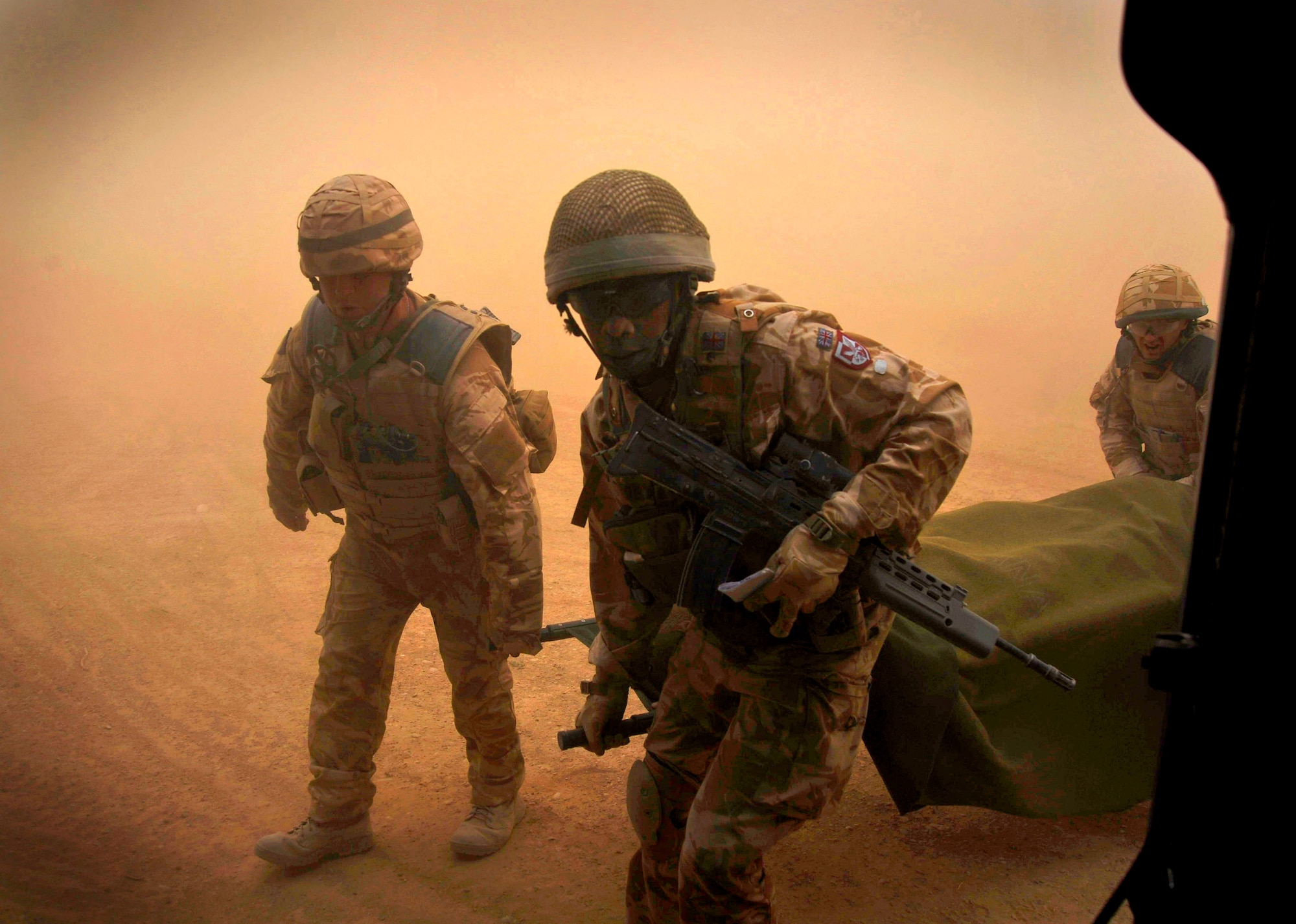 Pararescuemen receive an injured patient from coalition forces Dec. 8, 2009. The pararescuemen will administer medical care while in transit to a medical facility. The pararescuemen are assigned to the 66th Expeditionary Rescue Squadron deployed to Camp Bastion, Afghanistan. (U.S. Air Force photo/Staff Sgt. Angelita Lawrence) 