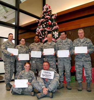 Members of Niagara Falls Air Reserve Station' s 914th Services Squadrondisplay care packages sent to them by Ginger Lindner of Clarence AmericanLegion Post Auxiliary 838, Clarence, N.Y. The post sent enough boxescontaining cookies, candy and other goodies so each of the 14 peopledeployed to the Air Force Mortuary Affairs Operations Center, Dover AirForce Base, Del., could enjoy some Christmas cheer.Pictured are (sitting) Staff Sgt. Sarah Hinds and Staff Sgt. Andrew Smith;(standing from left) Tech. Sgt. Christopher Penberthy, Senior Airman NicholeLeake, Senior Airman Shawn Warren, Tech. Sgt. Charles Jewell, Master Sgt.Kenneth Brophy and Master Sgt. Mark Dickinson.