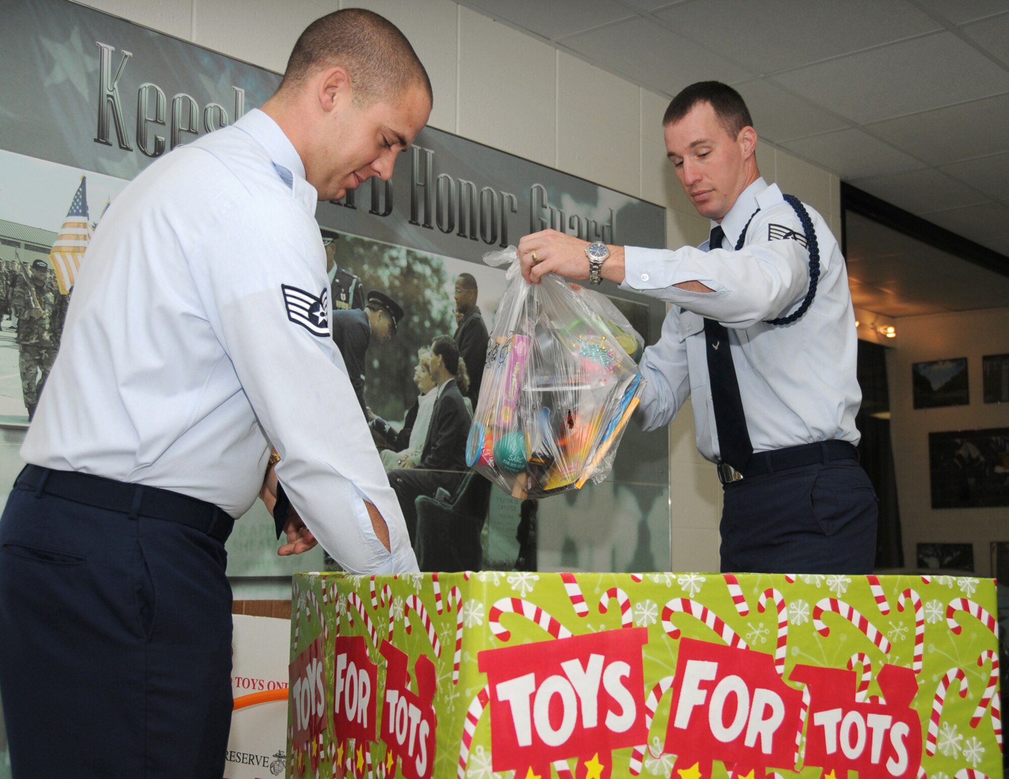 Staff Sgts. Edward Lotz, left, and Steven Clinton, military training leaders from the 336th Training Squadron, unload toys their students bought to support the Toys for Tots campaign.  The students used their own money to purchase more than 100 toys for the drive.  (U.S. Air Force photo by Kemberly Groue)