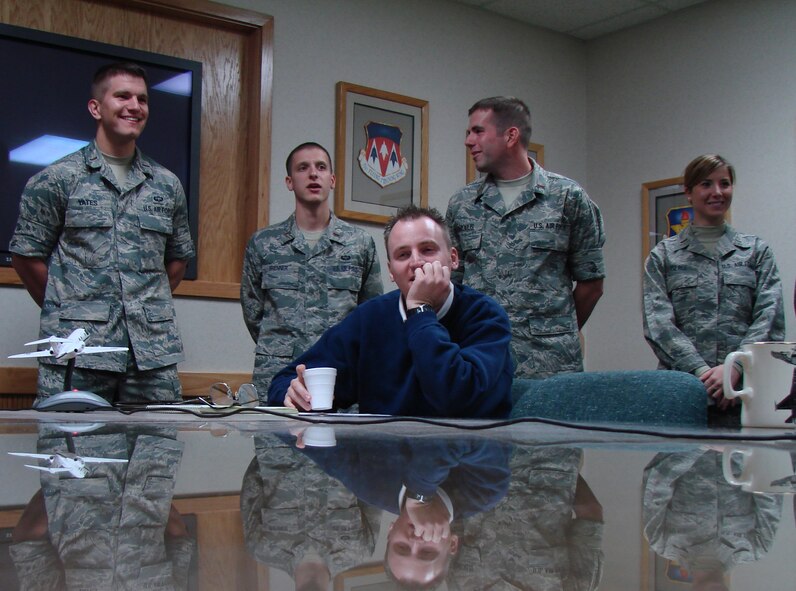 Audio Visual Specialist Chad Chambers calculates camera logistics as members
of "Team Wolf Pack," 2nd Lts. John Yates, Scott Brenner and Cari Pierce,
present their Joint Specialized Undergraduate Pilot Training graduation
dinner video concepts to 71st Flying Training Wing leadership Dec. 4. Two
teams of five competed with each other to create the most compelling concept
in a project launched by Col. Chris Nowland, 71st FTW commander, styled
after NBC's 'The Apprentice' television series.