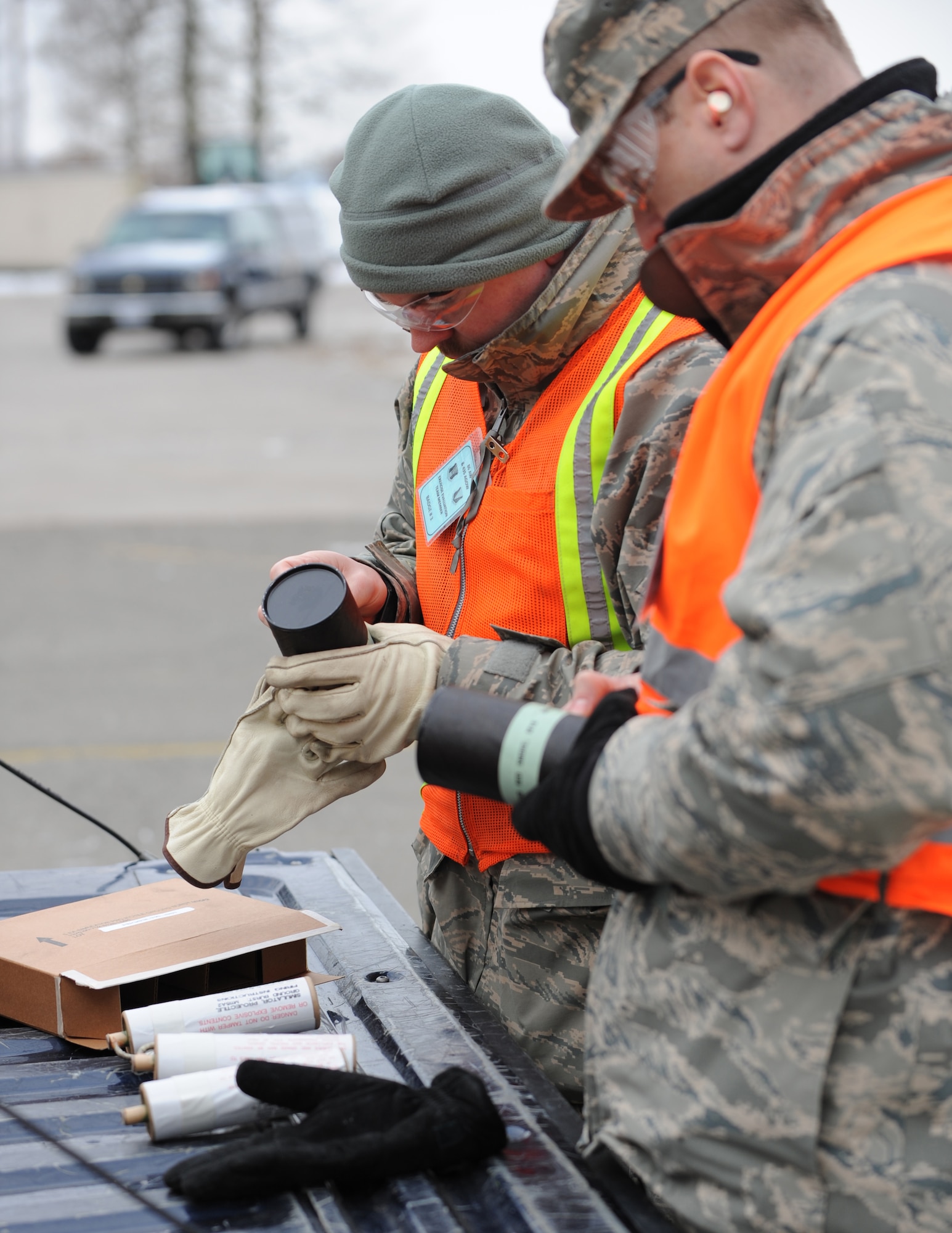U.S. Air Force Tech. Sgt. David Baughman and Master Sgt. Darrin Powers, members of the 86th Airlift Wing commanders vice inspection exercise development section, inspections and readiness, prepare charges for detonation simulations during an exercise,  Ramstein Air Base, Germany, Dec. 15, 2009. The wing is conducting an exercise to evaluate its mission readiness and the ability to survive and operate in a chemical environment. (U.S. Air Force photo by Airman 1st Class Caleb Pierce)