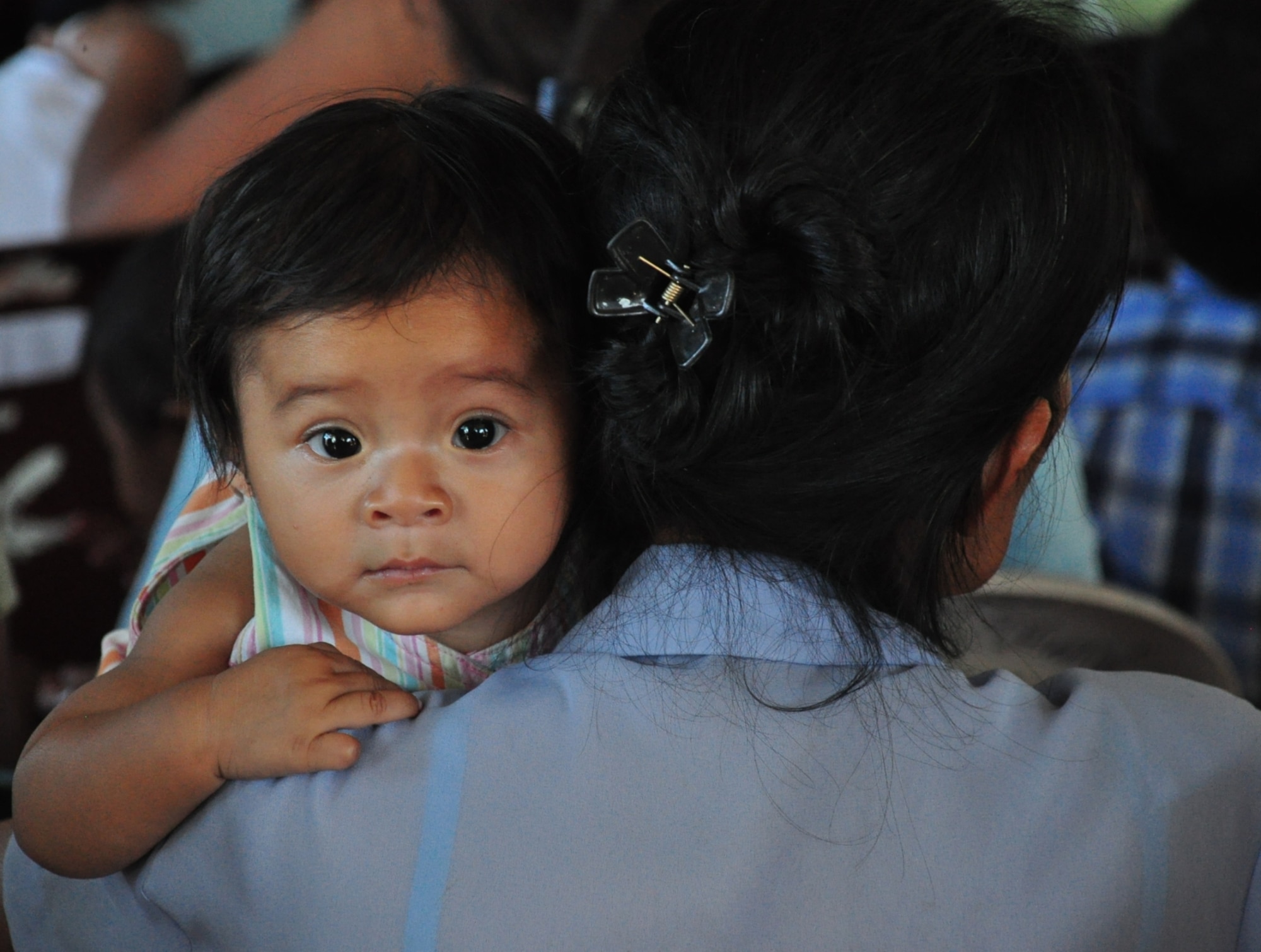 A baby waits as her mother attends a preventive medicine class prior to receiving vitamins, soap and medical care during a Medical Civil Action Program (MEDCAP) conducted by the Salvadoran Ministry of Health and Joint Task Force-Bravo, in San Agustin, El Salvador, Dec. 14, 2009. The MEDCAP, which continues tomorrow in El Achiotal, El Salvador, comes as a follow-up to earlier medical and relief efforts coordinated with the Ministry of Health, U.S. Southern Command, and the U.S. Embassy and Military Group in El Salvador. November flooding and mudslides killed more than 100 people and displaced many more in the area. (U.S. Air Force photo/Tech. Sgt. Mike Hammond)