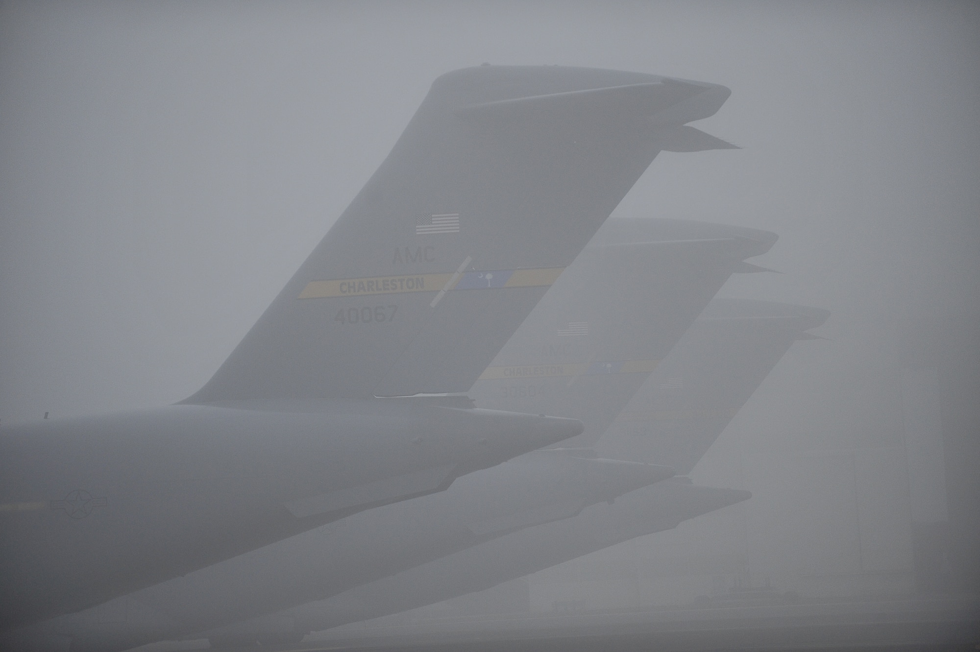 Charleston Air Force Base C-17s sit on the flightline during a foggy morning at Charleston AFB, S.C., Dec. 14, 2009. Charleston AFB is home to the 437th Airlift Wing. The wing has four operational groups consisting of 21 squadrons and one wing staff directorate. Charleston AFB is also host to the 315th Airlift Wing and 17 tenant units. (U.S. Air Force photo by James M. Bowman)(RELEASED)
