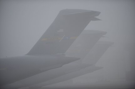 Charleston Air Force Base C-17s sit on the flightline during a foggy morning at Charleston AFB, S.C., Dec. 14, 2009. Charleston AFB is home to the 437th Airlift Wing. The wing has four operational groups consisting of 21 squadrons and one wing staff directorate. Charleston AFB is also host to the 315th Airlift Wing and 17 tenant units. (U.S. Air Force photo by James M. Bowman)(RELEASED)