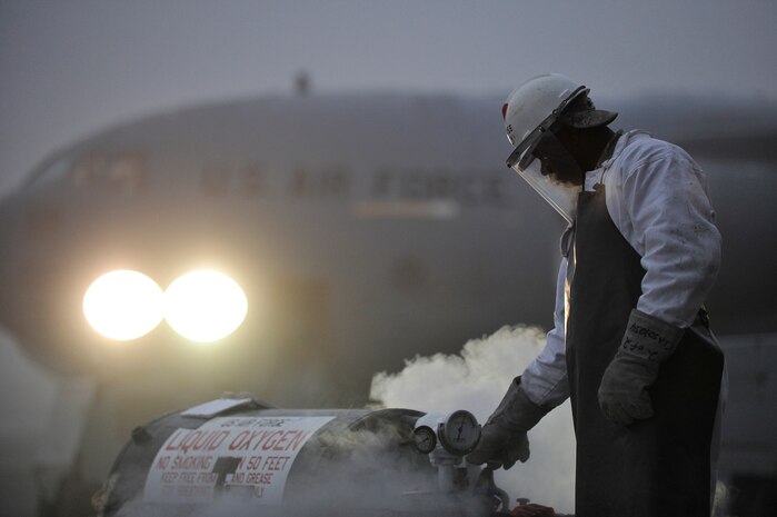 U.S. Air Force Staff Sgt. Rushad Stroman adjusts a liquid oxygen value while servicing a C-17 at Charleston Air Force Base, S.C., Dec. 14, 2009. The 437th Aircraft Maintenance Squadron at Charleston AFB primarily performs flightline tasks to include daily mission launch and recovery, pre- and post-flight inspections, maintenance troubleshooting, aircraft systems repair and modifications. Sergeant Stroman is an aircraft electrical environmental technician with the 437 AMXS. (U.S. Air Force photo by James M. Bowman)(RELEASED)