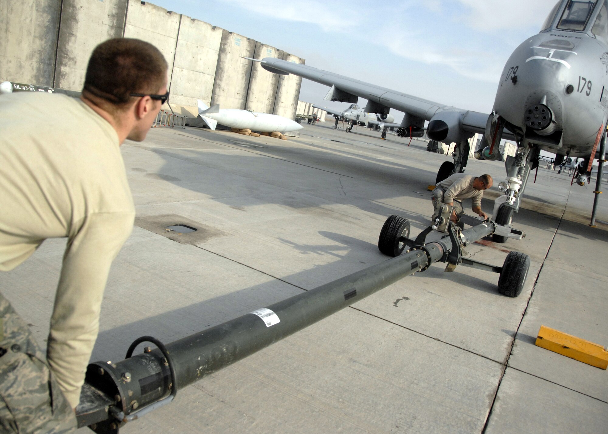 KANDAHAR AIRFIELD, Afghanistan -- Senior Airman Nathan Tierney (left) and Staff Sergeant Eddie Evans return an aircraft after an in-flight emergency here Dec. 10, 2009. Airman Tierney and Sergeant Evans are A-10 crash recovery troops with the 451st Expeditionary Maintenance Squadron Maintenance Flight.  (U.S. Air Force photo/Senior Airman Timothy Taylor)
