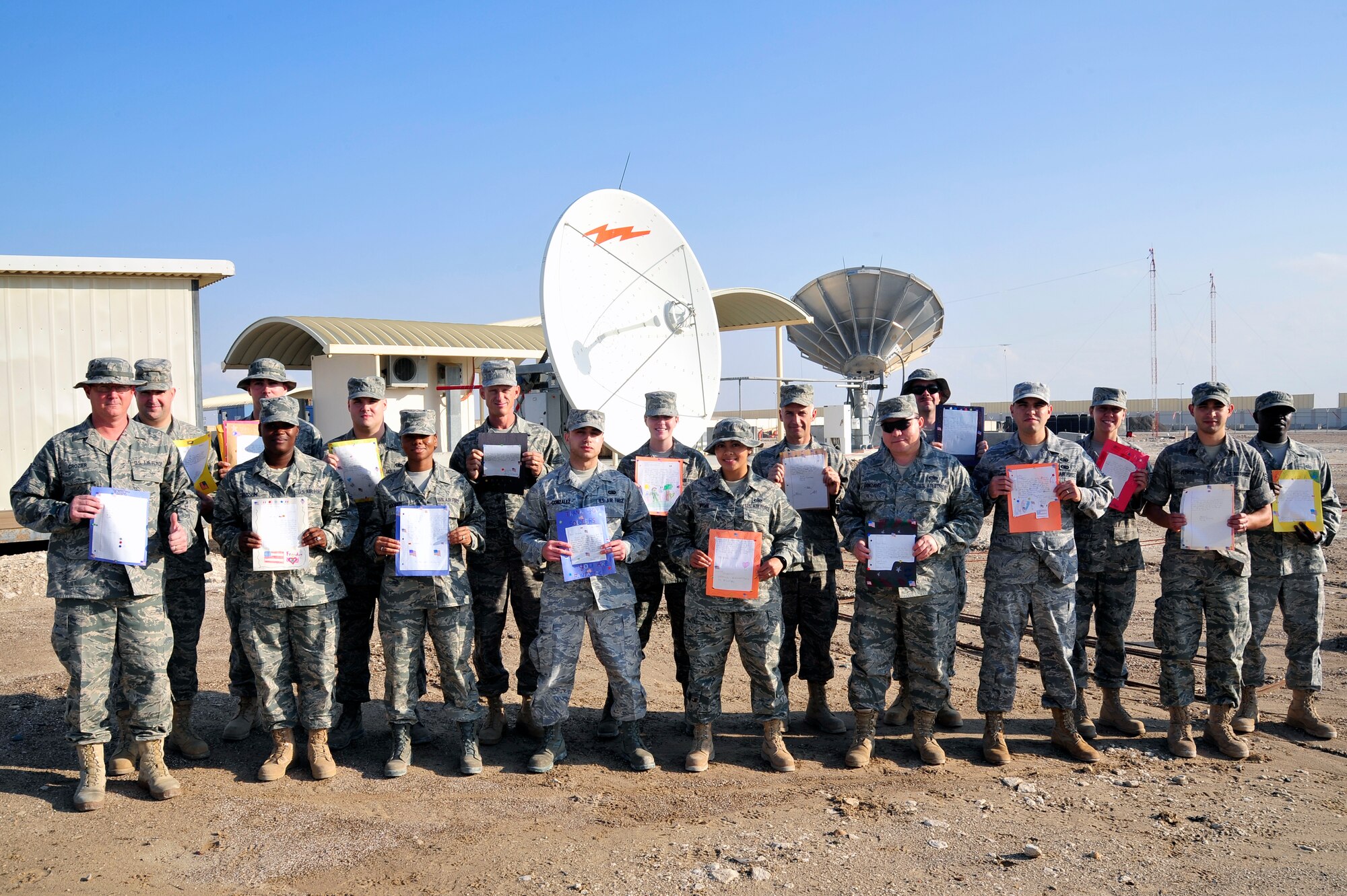 SOUTHWEST ASIA - Airmen from the 380th Expeditionary Communications Squadron hold letters received from U.S. elementary school children Dec. 14, 2009. The 380th ECS Airmen wrote a response to each of the children's letters, answering their questions and to let them know the letters were received by deployed servicemembers. (U.S. Air Force photo/Tech. Sgt. Charles Larkin Sr)
